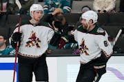 Arizona Coyotes defenseman Janis Moser, left, is congratulated by Phil Kessel (81) after scoring a goal against the San Jose Sharks during the second 