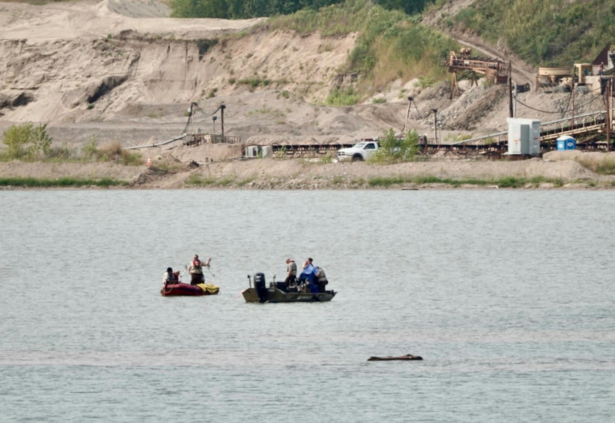 Investigators appeared to be viewing underwater cameras Monday at the site of the airplane crash.