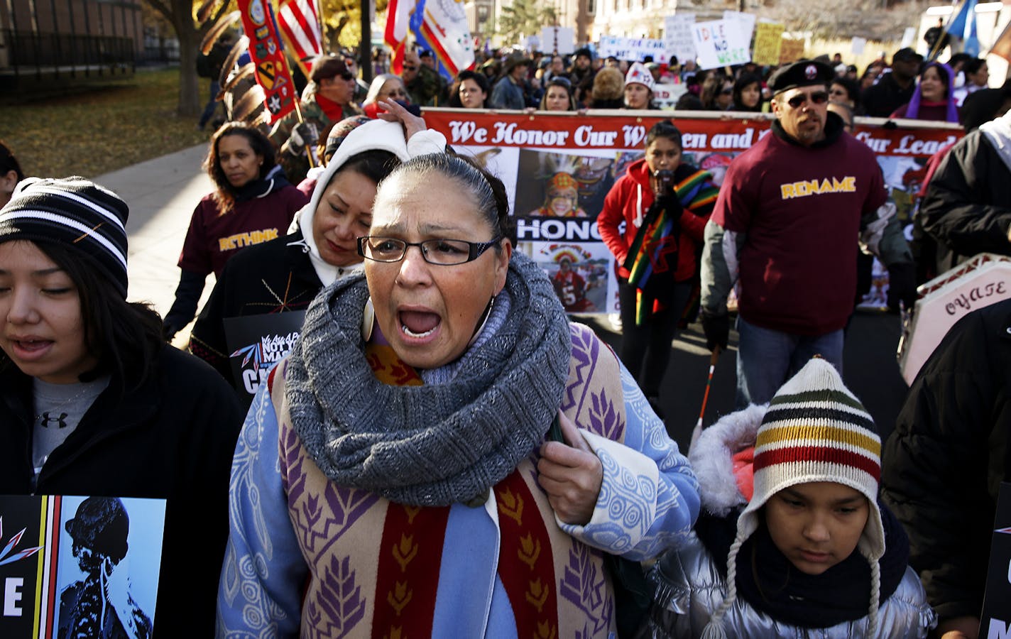 Dorene Day, an Ojibwe, sings the American Indian Movement theme song during a march with a coalition of tribal nations, Native American organizers, and the University of Minnesota to support retiring the Washington NFL team name and mascot before the Minnesota-Washington NFL game on November 2 at TCF Bank Stadium in Minneapolis. ] LEILA NAVIDI leila.navidi@startribune.com /