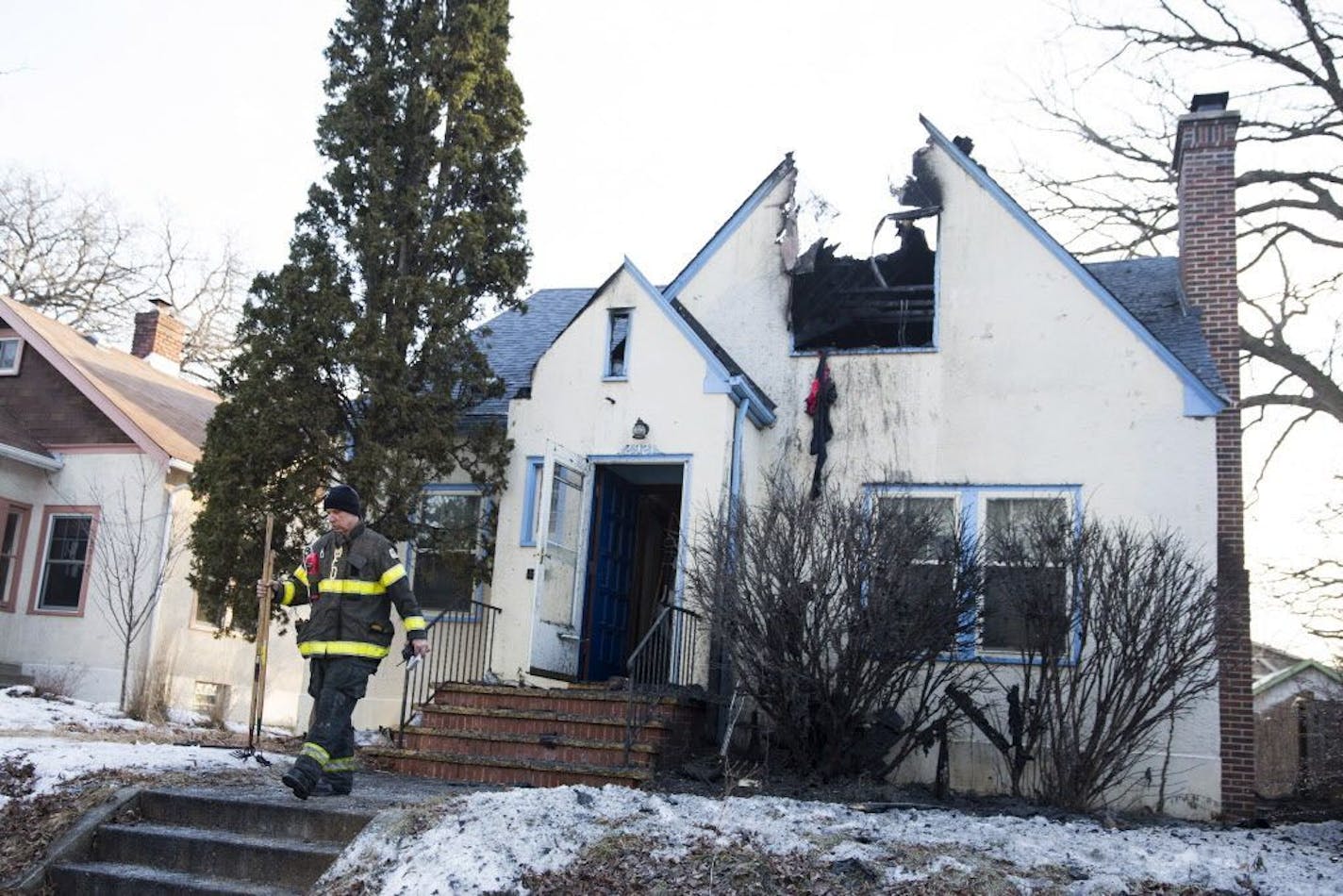 A Minneapolis firefighter leaves the scene of a home where a fire killed one man in Minneapolis on Sunday, February 21, 2016.