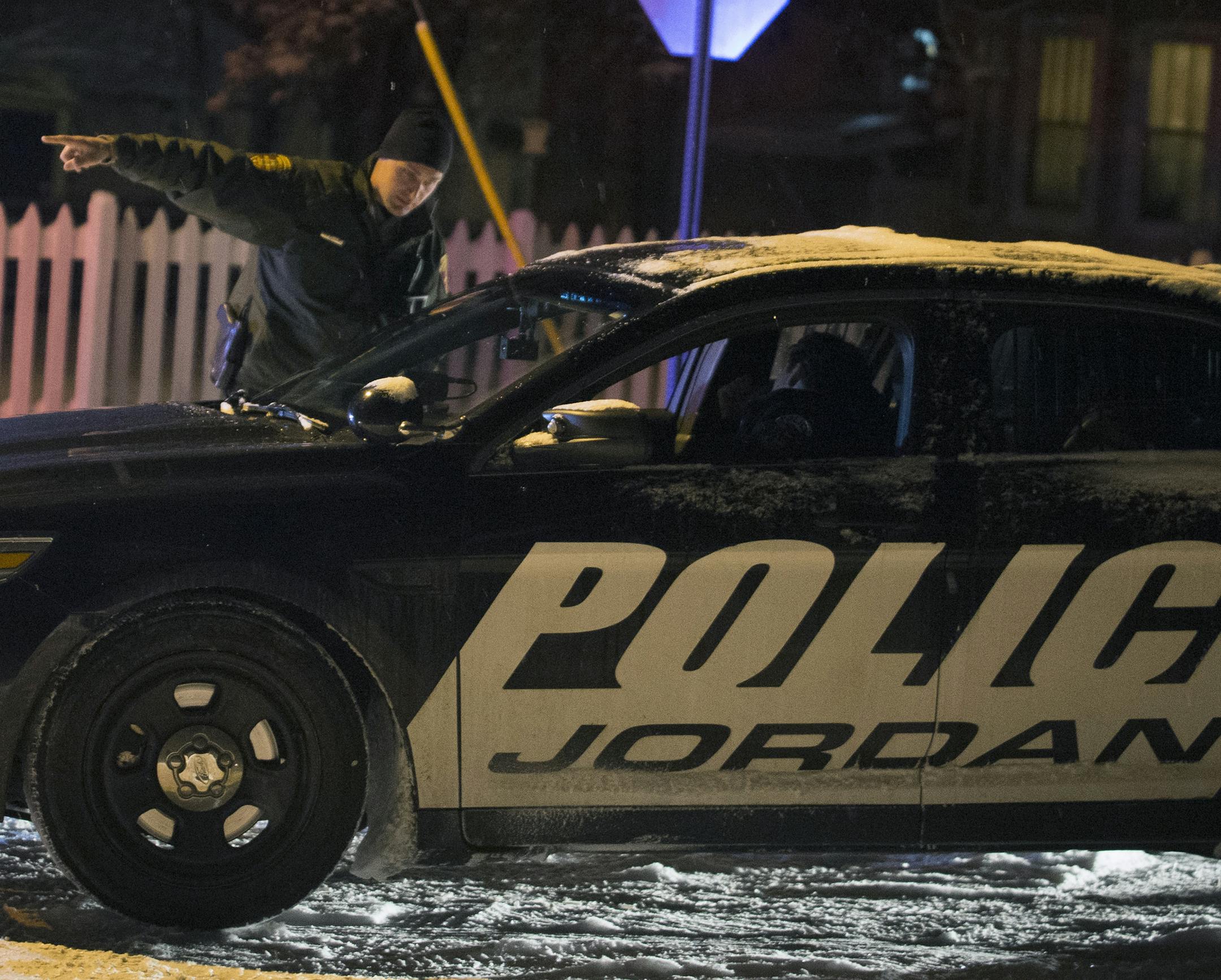 Police officers talk at a roadblock on Mertens Street at 3rd Street West on Tuesday night in Jordan near the scene of a standoff. ] (Aaron Lavinsky | StarTribune) Police respond to the scene of a standoff on the 400 block of Syndicate Street in Jordan, MN., on Tuesday, Feb. 3, 2015. ORG XMIT: MIN1502031929029450 ORG XMIT: MIN1502032054319499