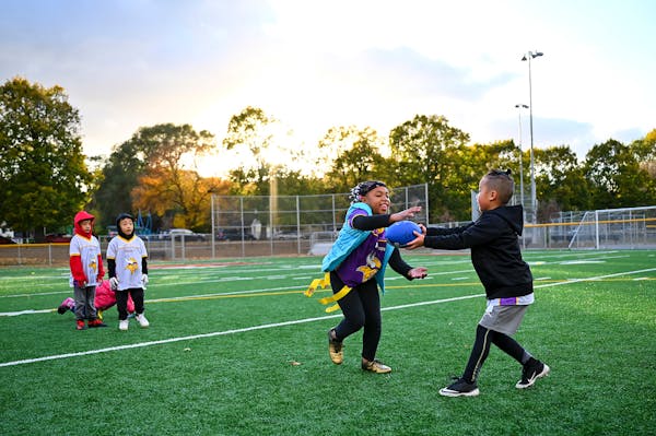 Chinyu Jordan Her, 6 handed off the ball to Catalia Farmer, 8 during flag football practice Wednesday night.