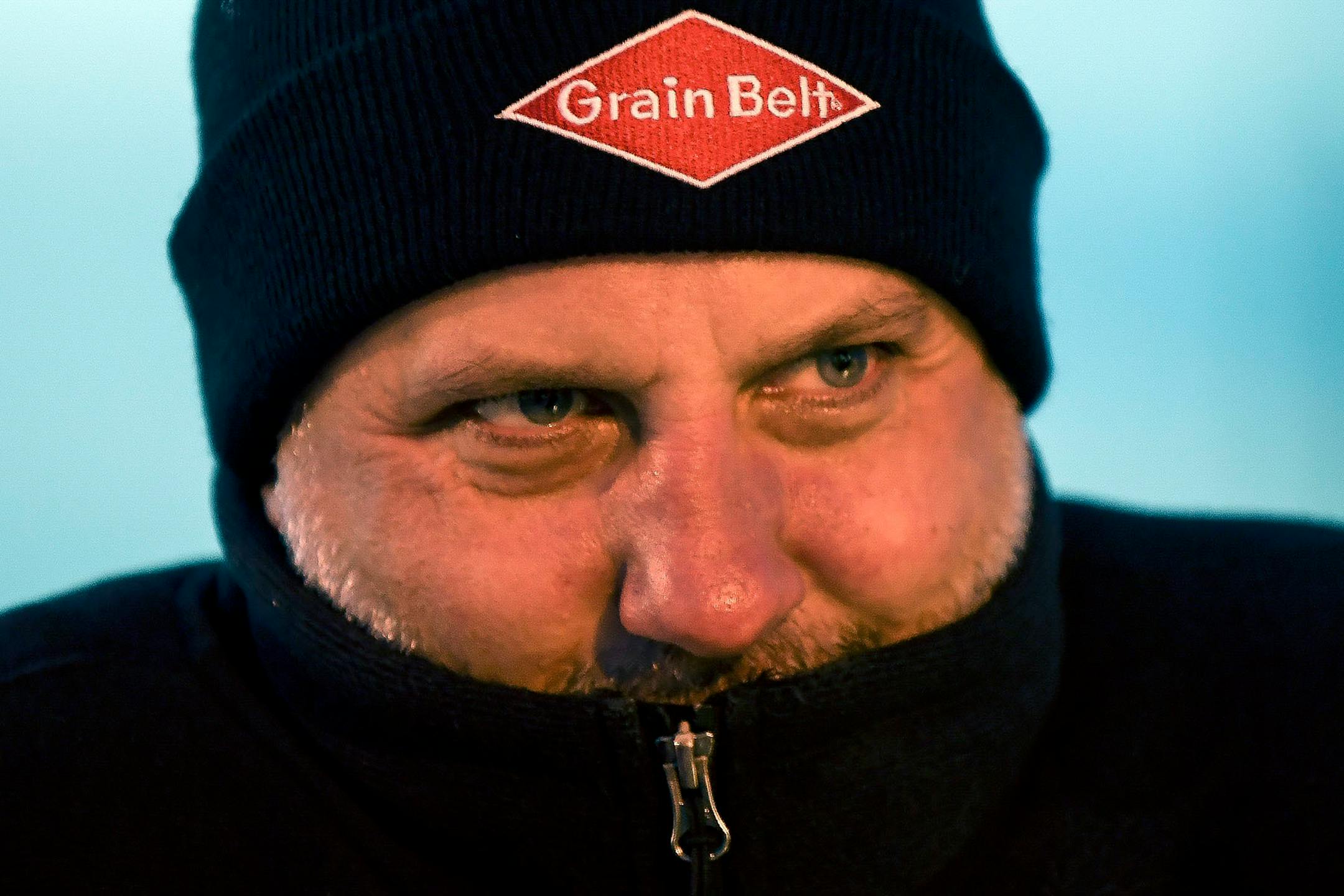 Brett Nelson, of Ham Lake, looked cold as he waited for the Grain Belt sign to be relit Saturday night.