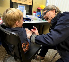 Jolie Holland, a licensed school nurse in the Howard Lake-Waverly-Winstead school district, gives a Winsted Elementary School student an insulin injec
