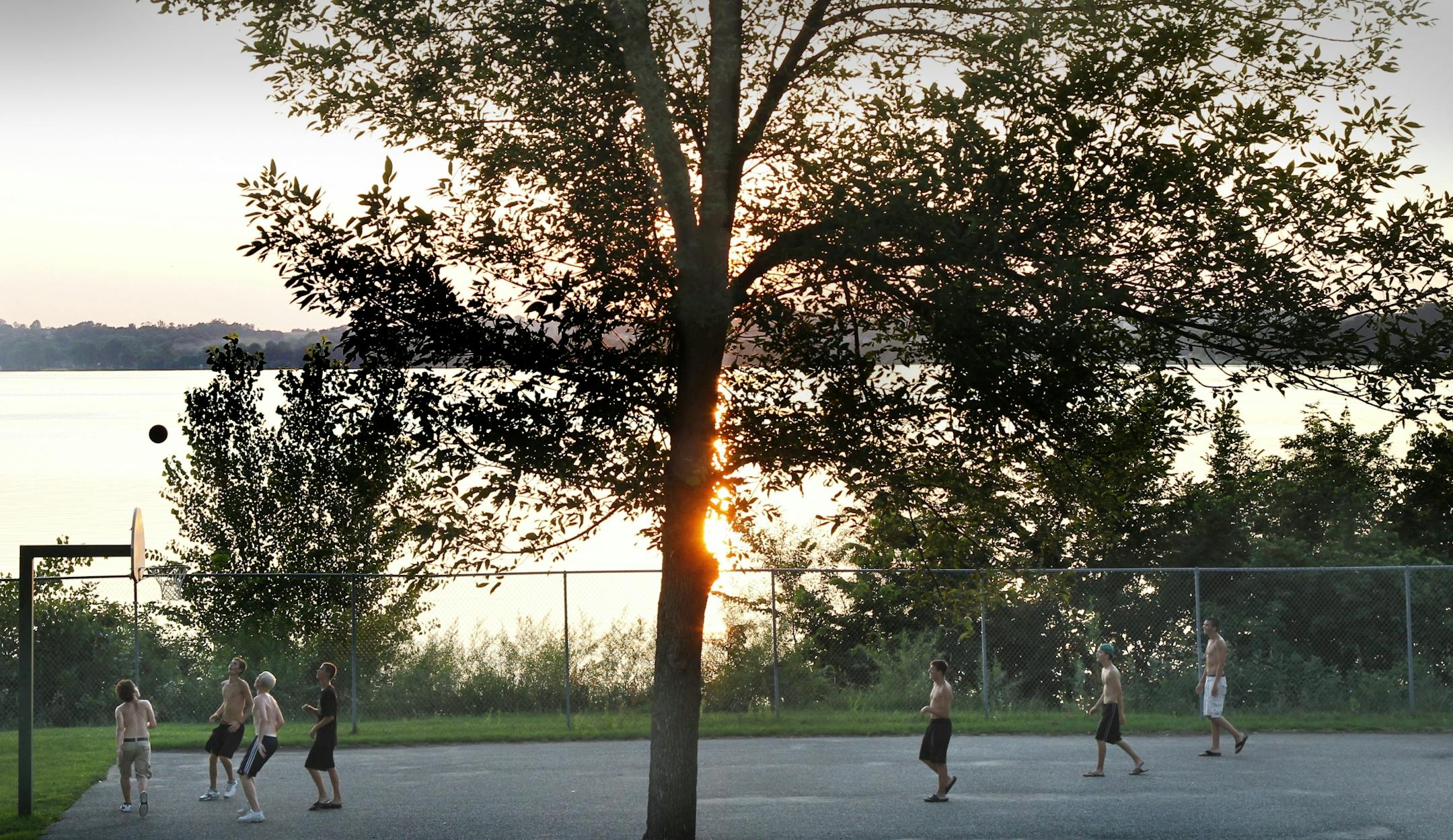 Buffalo Lake's Northwest corner has been developed into a great public space used by locals mostly. Highschool kids play basketball as the sun sets on Buffalo. - Assignments #20019135A_ August 5, 2011_ SLUG: buffalolake08xx_ EXTRA INFORMATION: __ Jeff Strickler - he's writing this lake profile.