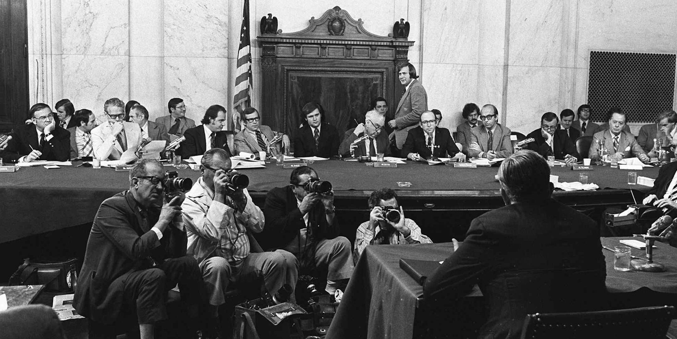 FILE - In this Aug. 3, 1973, file photo, the Senate Watergate Committee hearings continueon Capitol Hill in Washington. From left are: Sen. Lowell P. Weicker, Jr; Sen. Edward J. Gurney, Fred Thompson, Sen. Howard H. Baker, Jr; Rufus Edmisten, Sen. Sam Ervin; Sam Dash, Sen. Joseph M. Montoya, Sen. Daniel K. Inouye was absent. Testifying is Lt. Gen. Vernon Walters. In 1973, millions of Americans tuned in to what Variety called "the hottest daytime soap opera" _ the Senate Watergate hearings that e