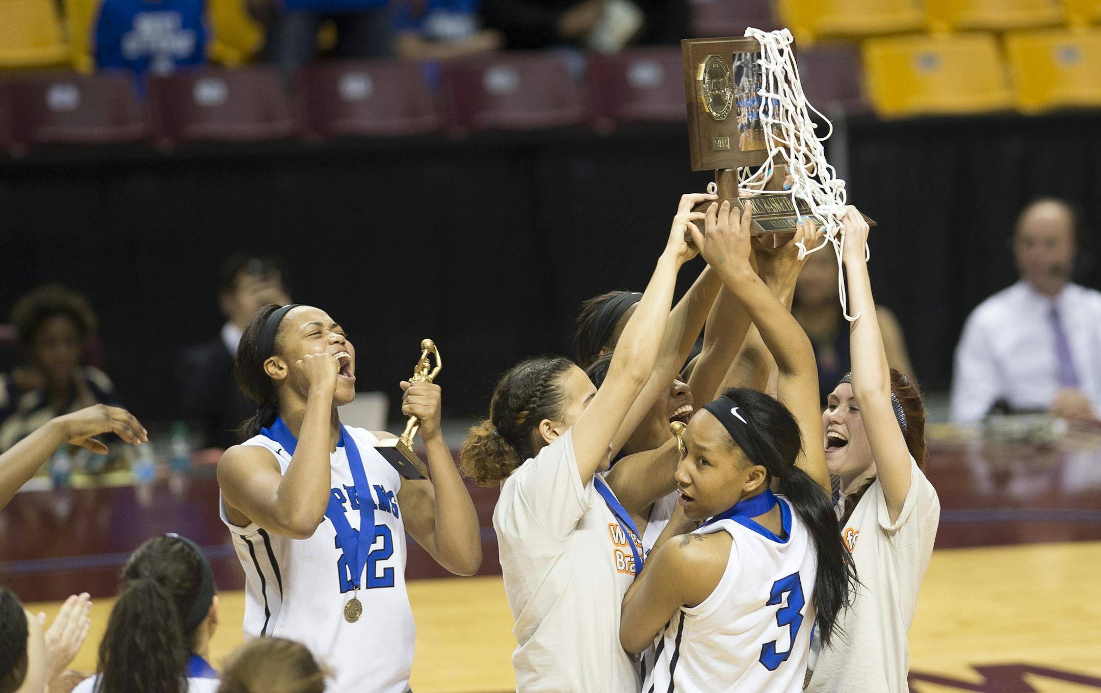 Hopkins players hoist their championship trophy above their heads after defeating Eastview in the Class 4A girls' basketball championship on Saturday night March 21. 2015 at Williams Arena in Minneapolis. Hopkins defeated Eastview 68-60. (AP Photo/Star Tribune, Aaron Lavinsky) MANDATORY CREDIT; ST. PAUL PIONEER PRESS OUT; MAGS OUT; TWIN CITIES LOCAL TELEVISION OUT
