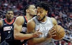 Minnesota Timberwolves' Derrick Rose drives around Houston Rockets' Gerald Green during the first half in Game 1 of a first-round NBA basketball playo