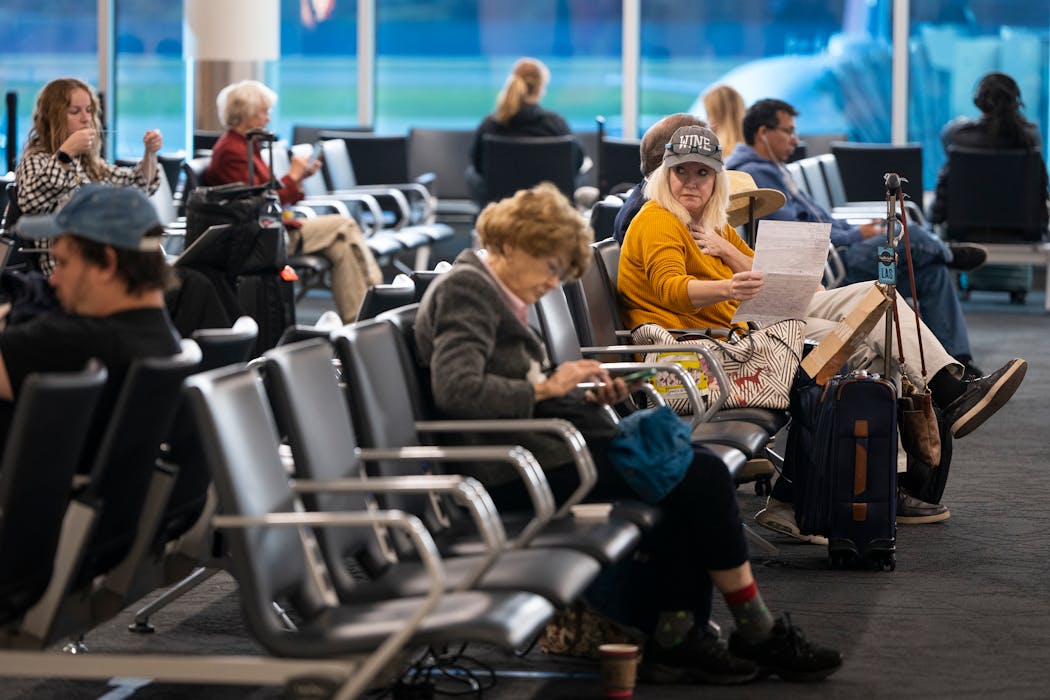 Passengers sat in Concourse G in Terminal 1, a portion of which completed renovations in 2022, at Minneapolis-St. Paul Airport on Thursday.