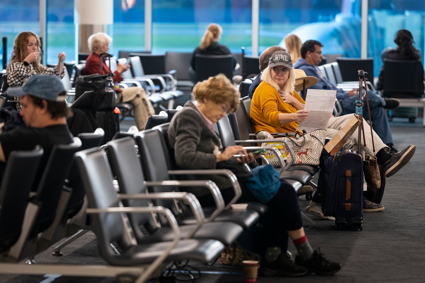 Passengers sit in Concourse G in Terminal 1, which completed renovations in 2022, at Minneapolis - St. Paul Airport in St. Paul, Minn. on Thursday, Nov. 9, 2023. The Metropolitan Airports Commission and Delta Air Lines, MSP's dominant airline, announced $242 million in interior renovations at Terminal 1. The project will transform six concourses and 75 gate areas. It will be the single largest renovation at the main terminal since 1962. ] LEILA NAVIDI • leila.navidi@startribune.com