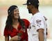 Minnesota Twins left fielder Eddie Rosario surprised The Bachelorette, Becca Kufrin, with a rose after he caught her ceremonial first pitch before the
