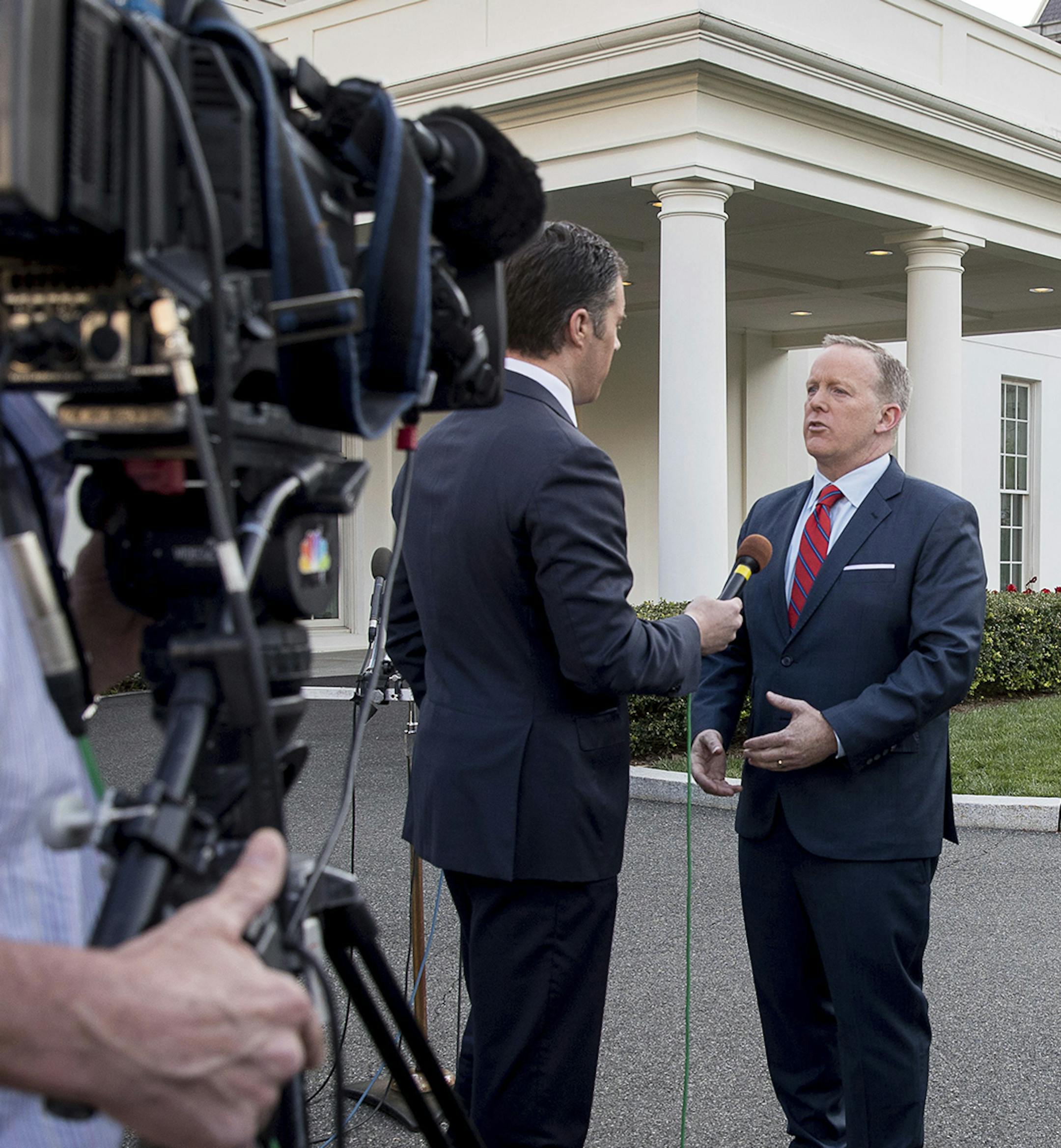 White House press secretary Sean Spicer, speaks to a reporter outside the West Wing of the White House, Tuesday, April 11, 2017, in Washington. Spicer is apologizing for making an "insensitive" reference to the Holocaust in earlier comments about Syrian President Bashar Assad's use of chemical weapons. (AP Photo/Andrew Harnik) ORG XMIT: MIN2017041311113908