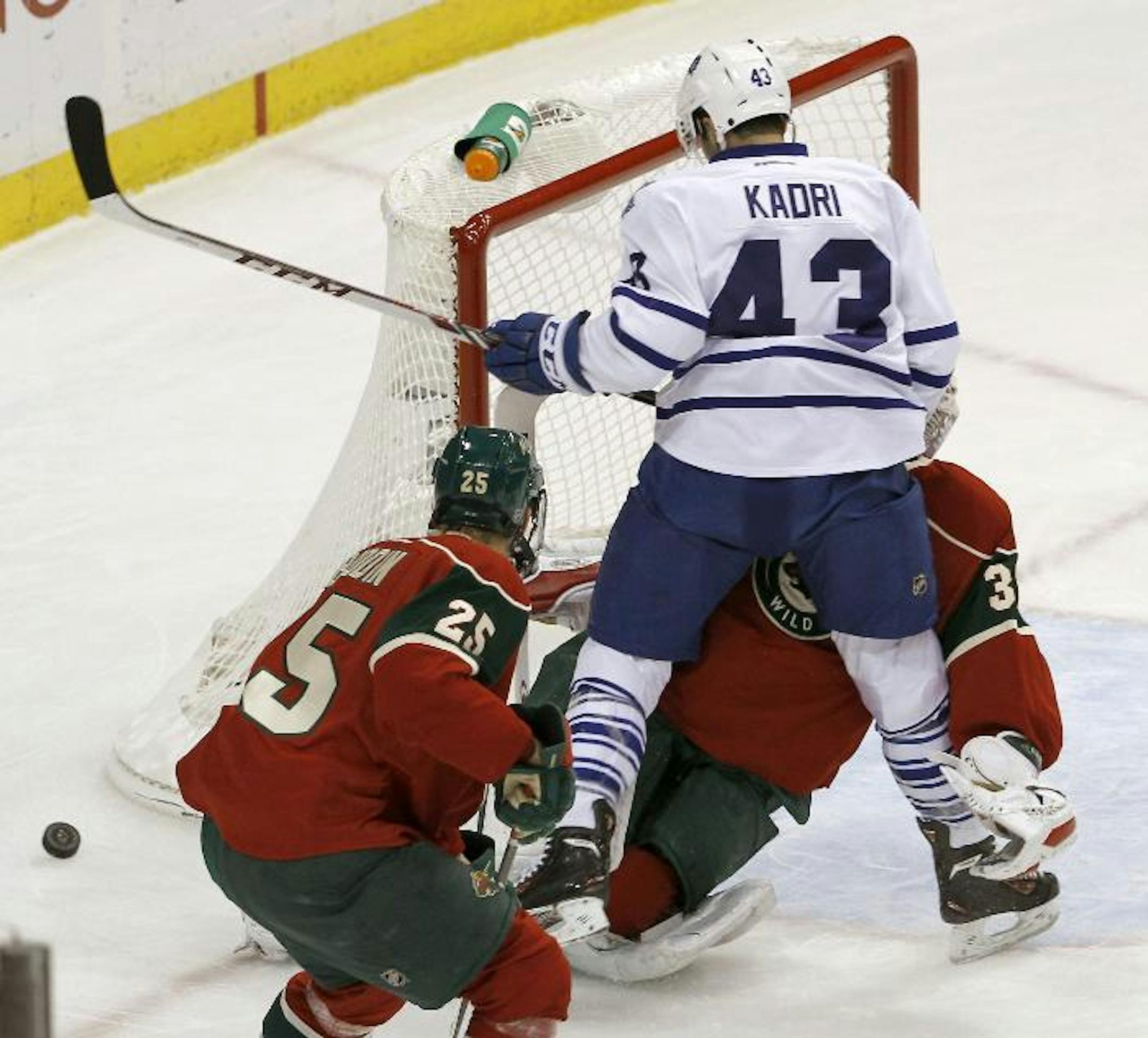 Toronto Maple Leafs center Nazem Kadri (43) collides with Minnesota Wild goalie Niklas Backstrom, of Finland, during the first period of an NHL hockey game in St. Paul, Minn., Wednesday, Nov. 13, 2013. Backstrom left the game later in the period.