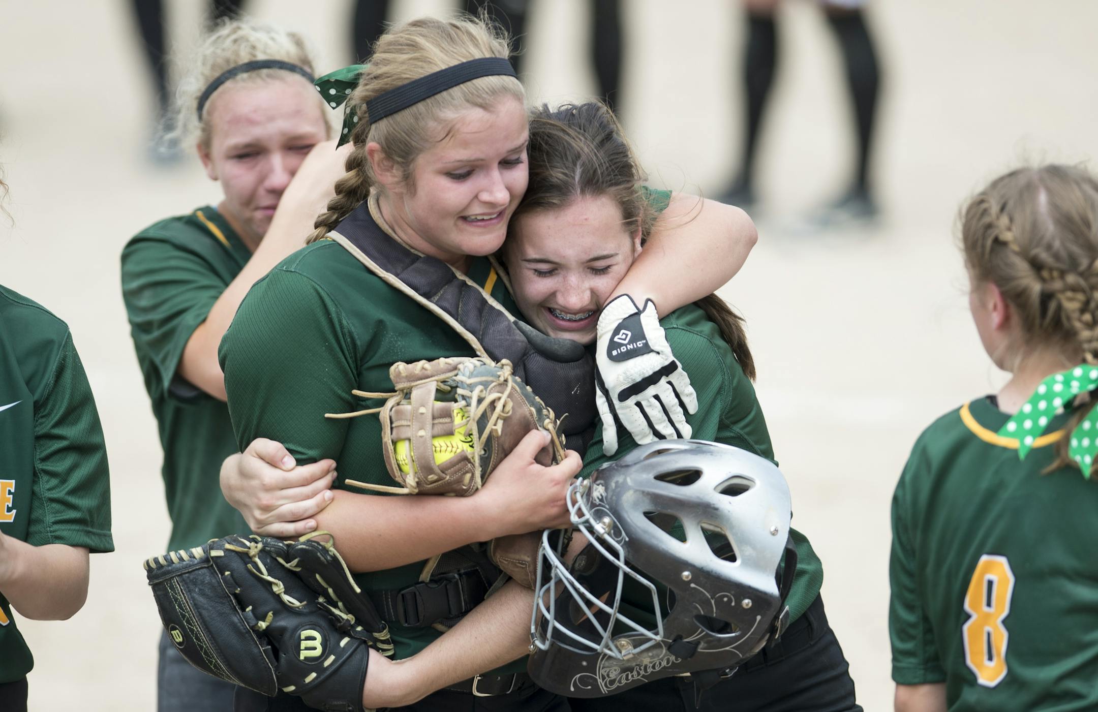 New Life Academy of Woodbury catcher Malorie Giere, left, and second baseman Elena Linster (2) hugged after their victory over Badger/Greenbush- Middle River in the 1A championship game Friday. ] Aaron Lavinsky • aaron.lavinsky@startribune.com The softball state tournament finals were held Friday, June 5, 2015 at Caswell Park in Mankato.