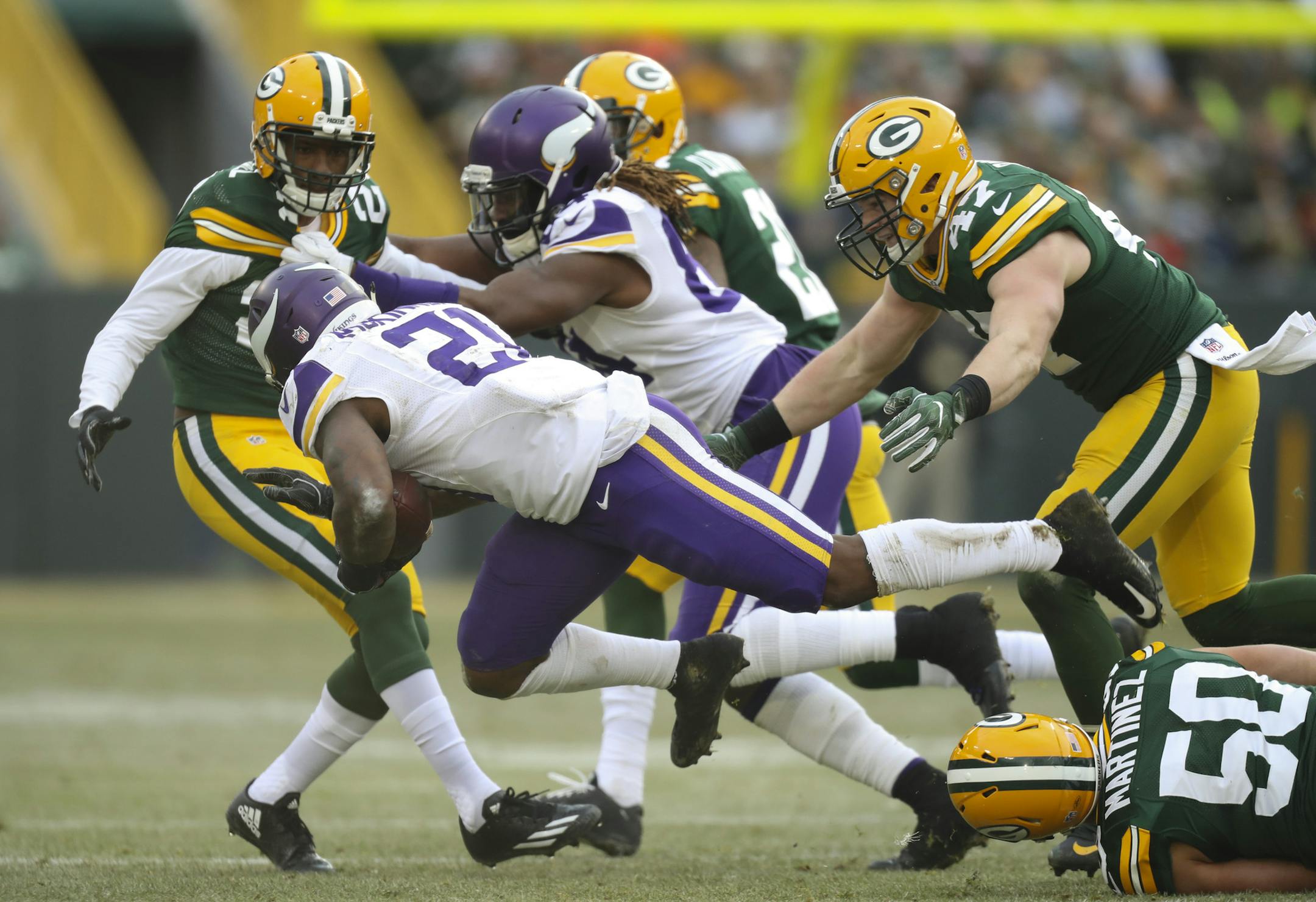 Vikings running back Jerick McKinnon (21) was tripped up after gaining two yards on a third quarter run by Green Bay Packers inside linebacker Blake Martinez (50). ] JEFF WHEELER &#xef; jeff.wheeler@startribune.com The Vikings lost 38-25 to the Green Bay Packers in an NFL football game Saturday afternoon, December 24th, 2016 at Lambeau Field in Green Bay, WI. ORG XMIT: MIN1612241648130251