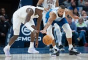 Cleveland Cavaliers guard Caris LeVert (3) and Minnesota Timberwolves center Rudy Gobert (27) fight for a loose ball in the fourth quarter.