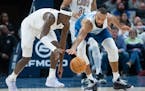 Cleveland Cavaliers guard Caris LeVert (3) and Minnesota Timberwolves center Rudy Gobert (27) fight for a loose ball in the fourth quarter.