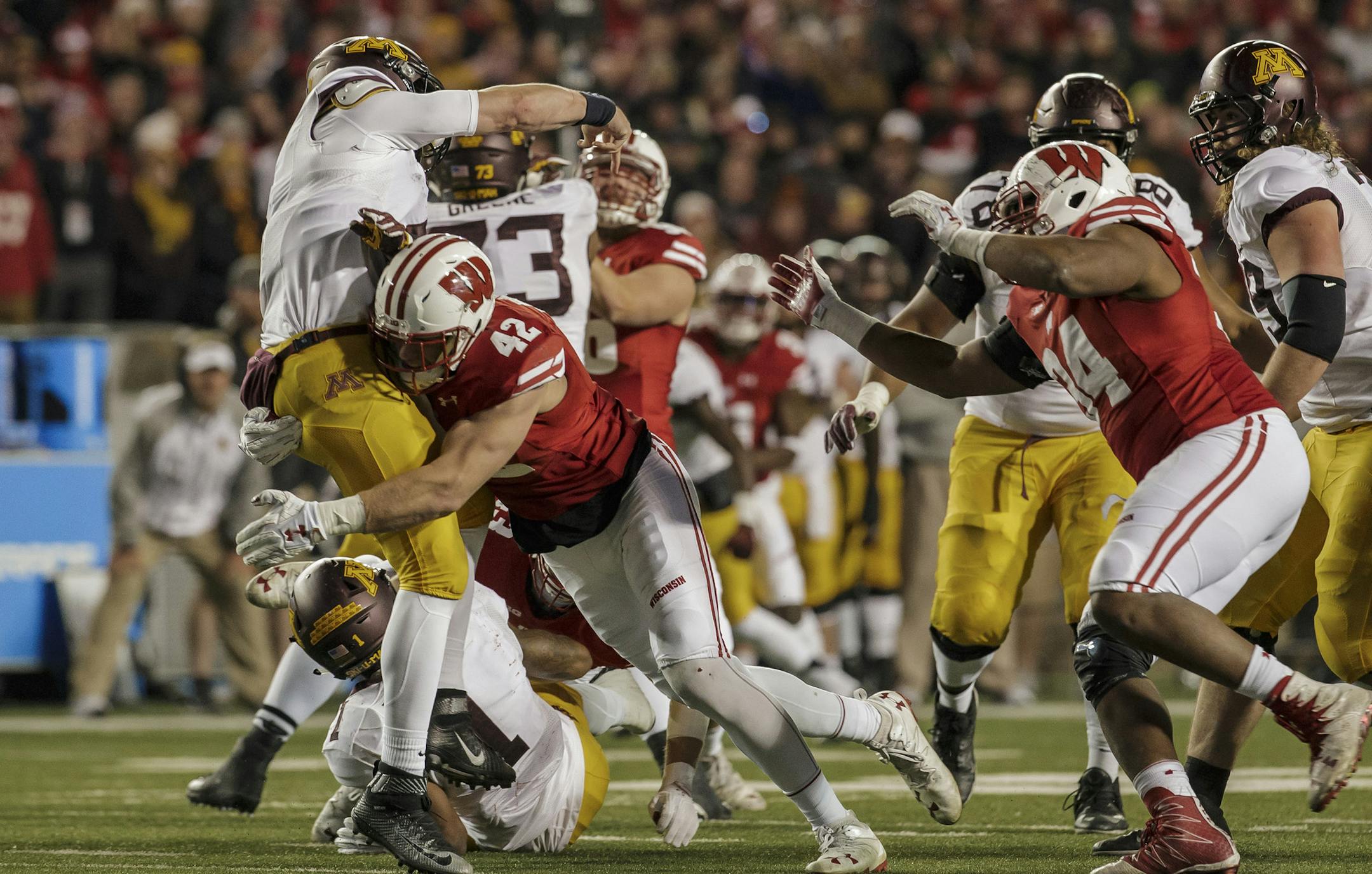 MADISON, WI - NOVEMBER 26: Wisconsin Badgers outside linebacker T.J. Watt (42) gets pressure on Minnesota Golden Gophers quarterback Mitch Leidner (7) durning an NCAA Football game between the 6th ranked Wisconsin Badgers and the Minnesota Golden Gophers for Paul Bunyan's Axe at Camp Randall Stadium in Madison Wisconsin on November 26th, 2016. Wisconsin defeats Minnesota 30-17 to retain the axe. (Photo by Dan Sanger/Icon Sportswire) (Icon Sportswire via AP Images) ORG XMIT: 265446