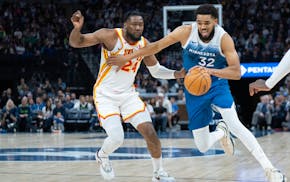 Timberwolves center Karl-Anthony Towns drives on Hawks forward Bruno Fernando on Friday, Towns' first game back from a lengthy injury hiatus. He figur