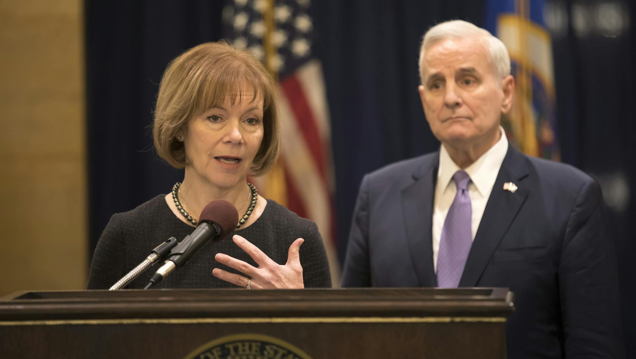 Minnesota Gov. Mark Dayton listens to Lt. Gov. Tina Smith as she was named to replace fellow Democrat Al Franken in the U.S. Senate on Wednesday, Dec. 13, 2017 in St. Paul, Minn. Franken announced his resignation last week amid growing sexual misconduct allegations. (Brian Peterson/Star Tribune via AP)
