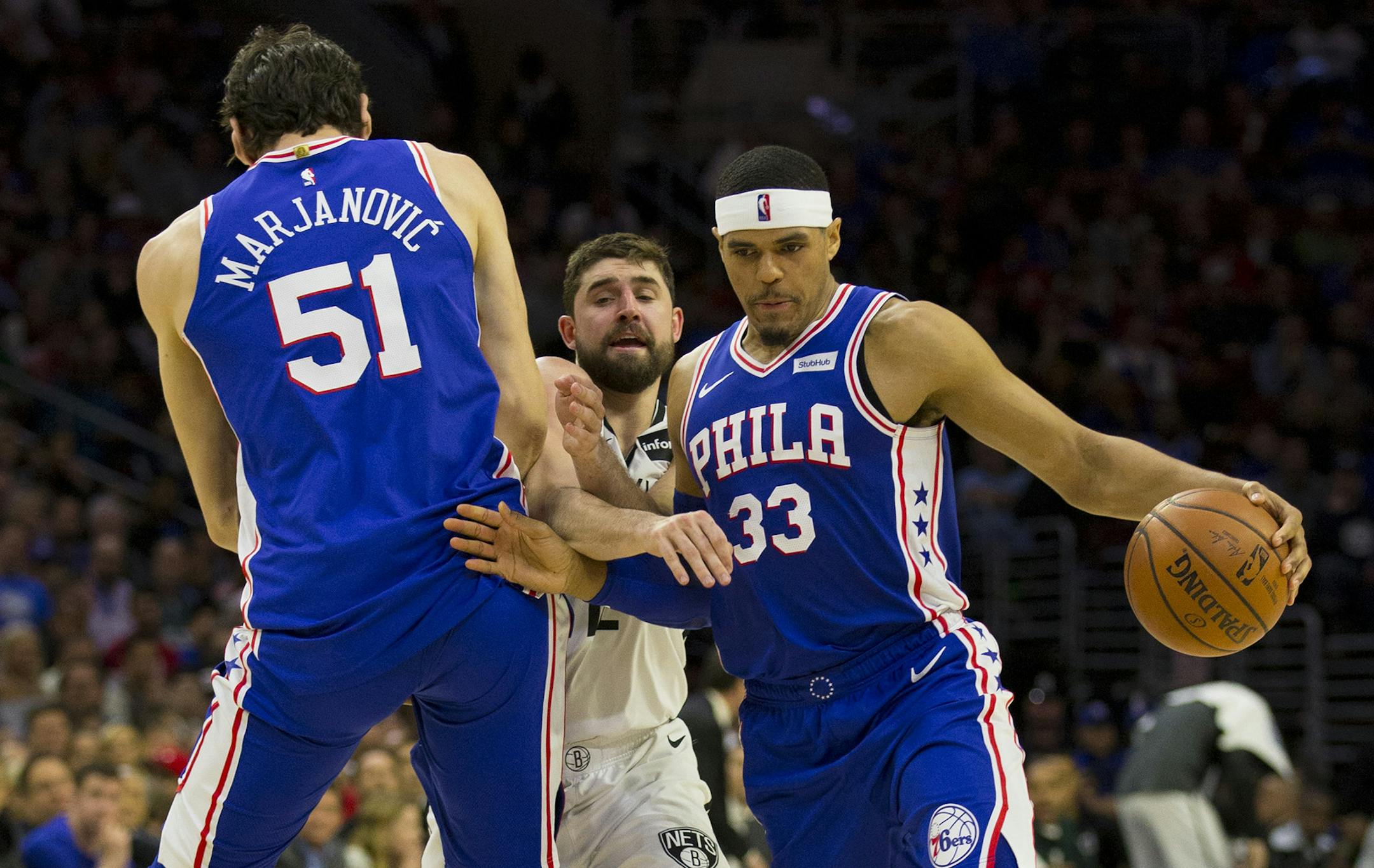 Tobias Harris #33 of the Philadelphia 76ers dribbles around a screen by teammate Boban Marjanovic #51 against Joe Harris #12 of the Brooklyn Nets in the third quarter of Game Two of Round One of the 2019 NBA Playoffs at the Wells Fargo Center on April 15, 2019 in Philadelphia, Pa. The 76ers defeated the Nets 145-123. (Mitchell Leff/Getty Images/TNS) ORG XMIT: 1303105