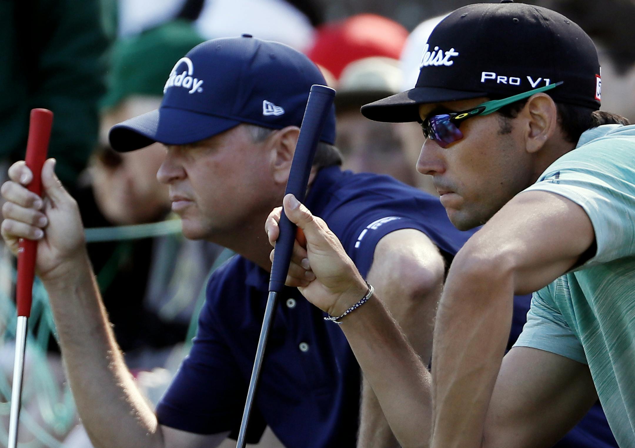 Rafae Cabrera Bello, of Spain, and Davis Love III line up putts on the seventh hole during the second round of the Masters golf tournament Friday, April 8, 2016, in Augusta, Ga. (AP Photo/David J. Phillip)