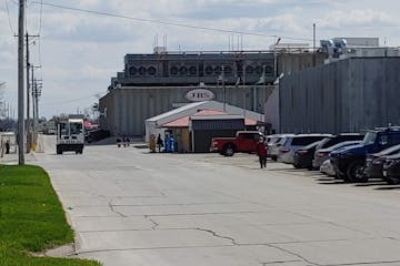 Workers enter a temperature-taking station at the JBS pork plant in Marshalltown, Iowa, on Monday, April 27.