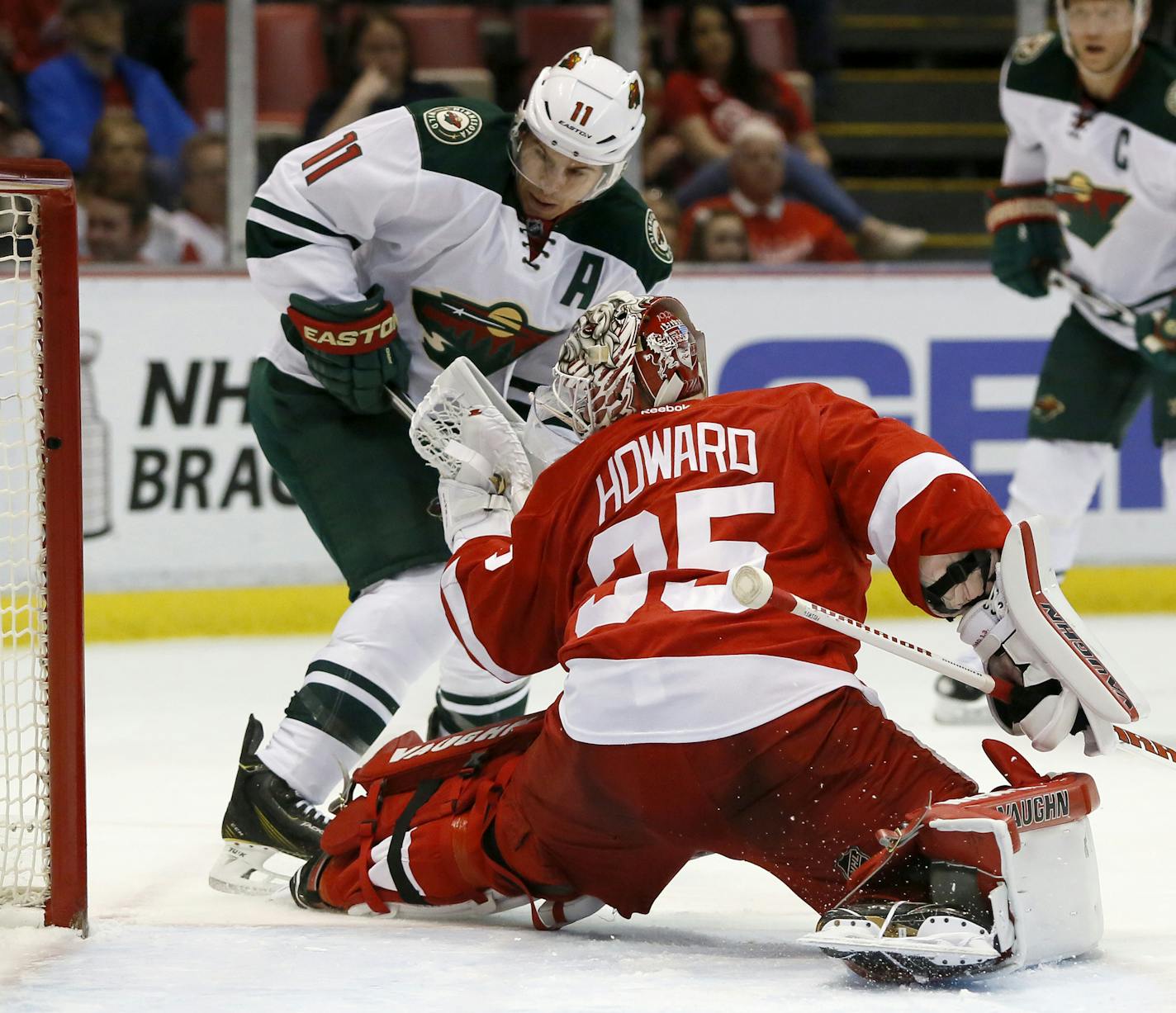 Minnesota Wild's Zach Parise (11) tries to take a shot on goal against Detroit Red Wings' Jimmy Howard (35) during the first period of an NHL hockey game Friday, April 1, 2016, in Detroit. (AP Photo/Duane Burleson)