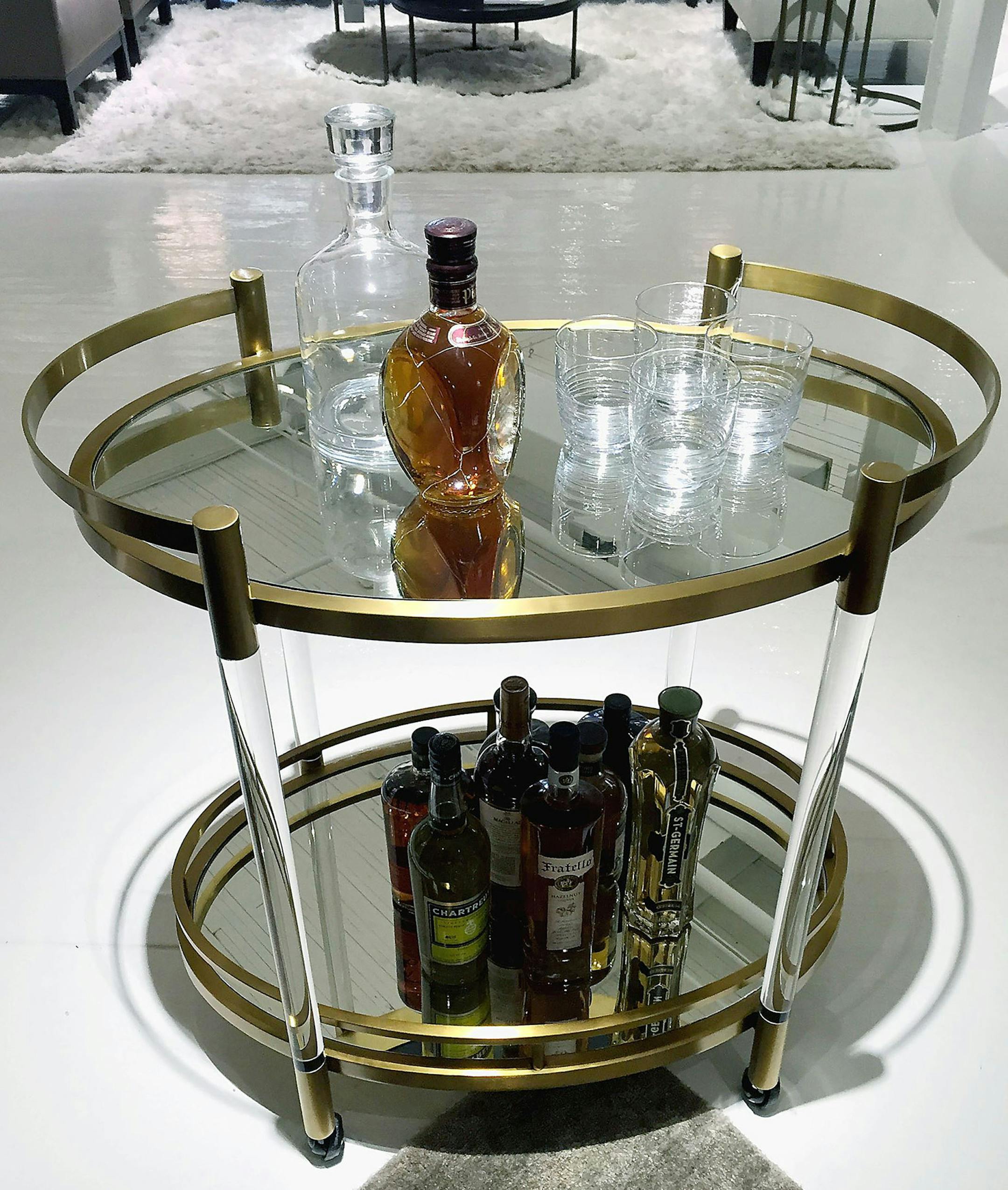 The Beverly bar cart by Mitchell Gold + Bob WIlliams employs acrylic, satin brass and mirrors to make a splash. (Patricia Sheridan/Pittsburgh Post-Gazette/TNS) ORG XMIT: 1187682