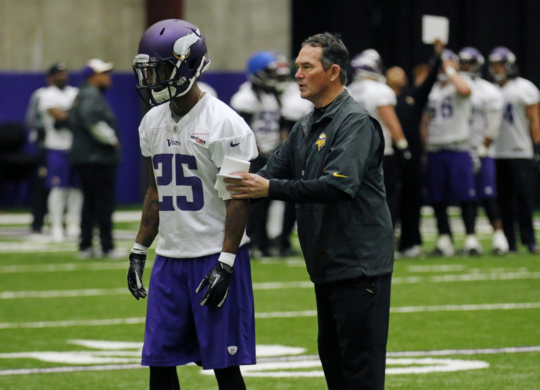 Vikings coach Mike Zimmer, get's hands on with his players at mini camp on Wednesday, including Kip Edwards