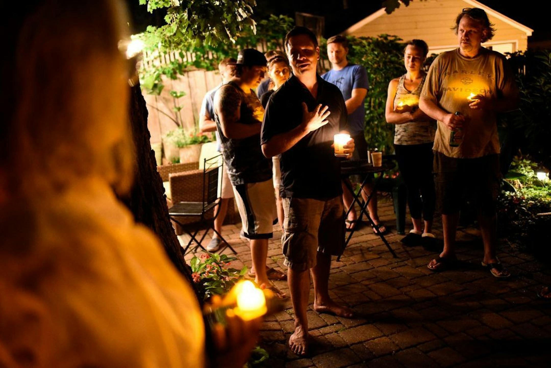 Don Damond thanked friends and neighbors for attending a candlelight vigil for Justine Damond Ruszczyk on the one year anniversary of her death as they collected candles for the vigil in Damond's back yard.