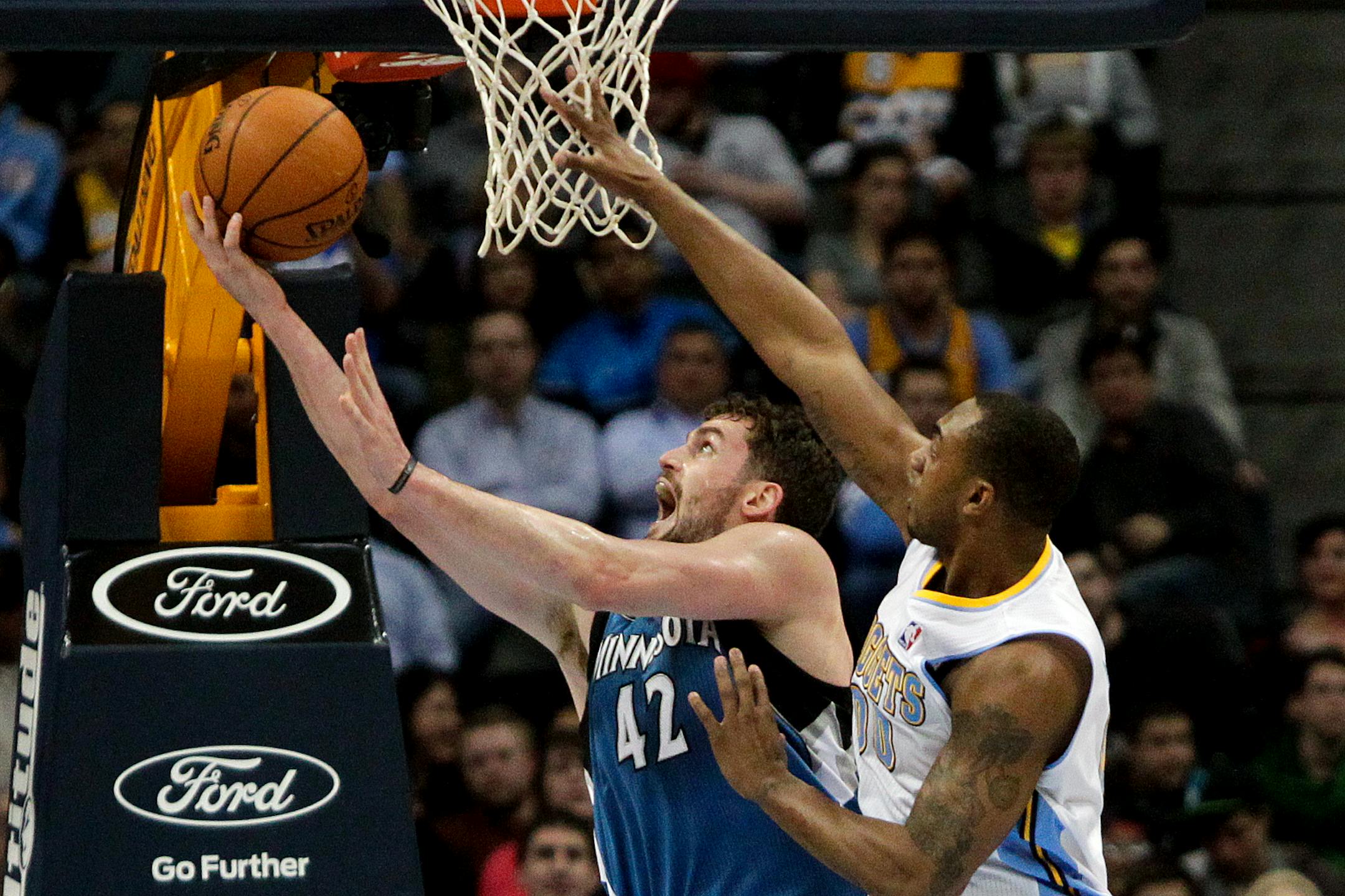 Wolves forward Kevin Love made a layup past Denver's Darrell Arthur.