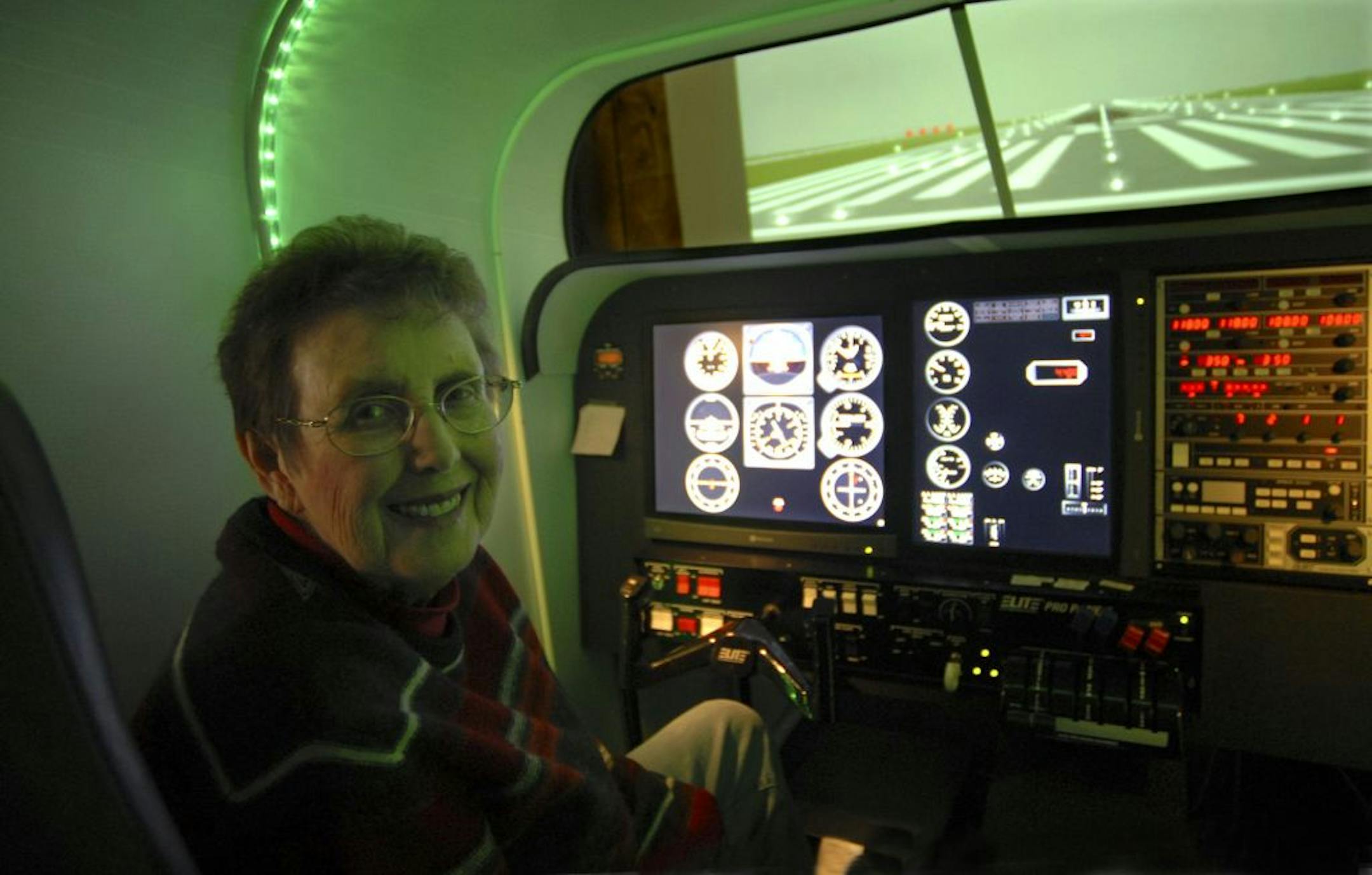 Master Flight Instructor Linda Dowdy sat in her flight simulator at Sim Flight Minnesota at the Anoka County Airport. The equipment simulates a single engine, multi-engine and turboprop.