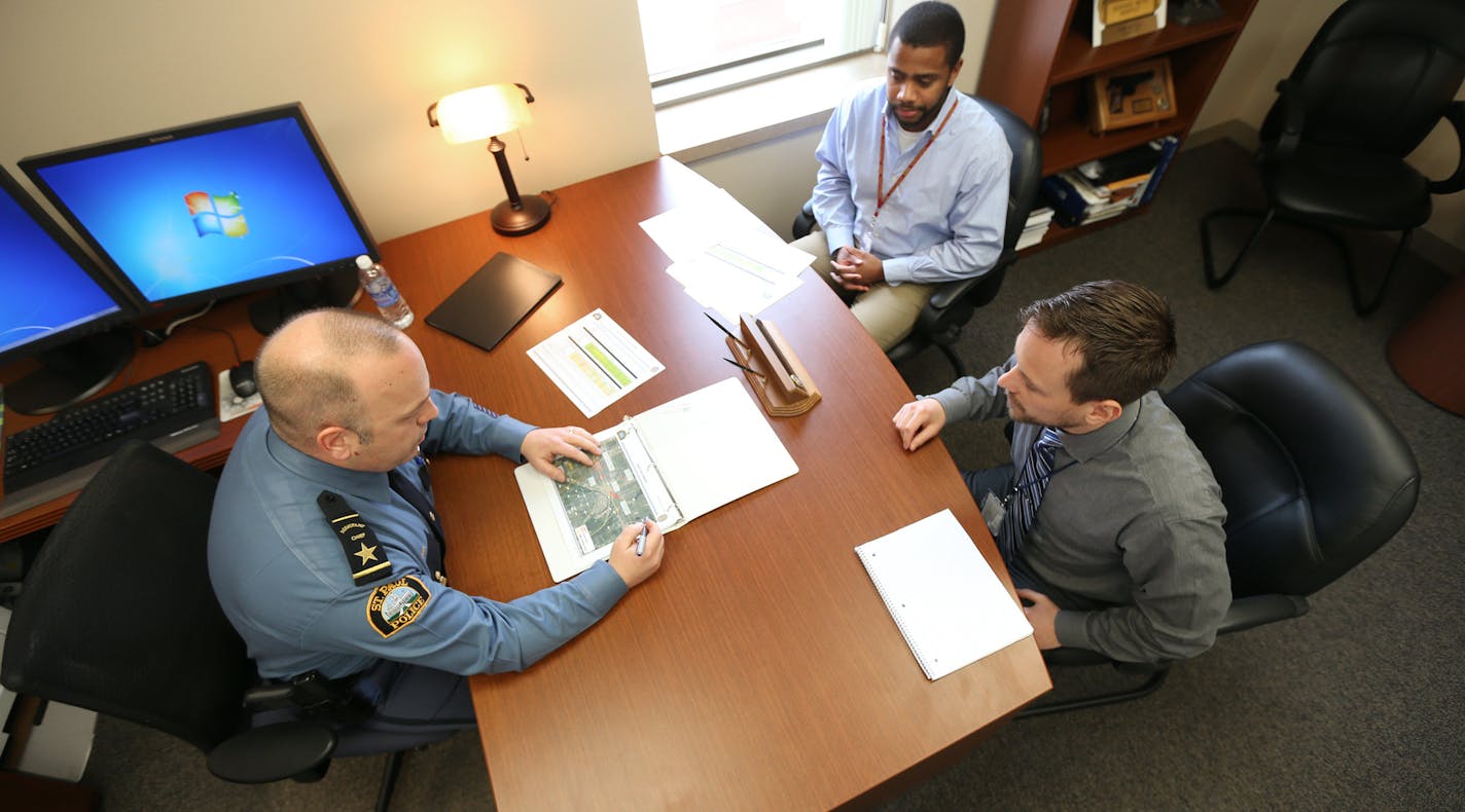 Todd Axtell assistant chief left, talked with analyst-operations civilian employees Karl Battle, and Joseph Reiter at St. Paul Police department headquarters Wednesday Feb 24, 2016 in St. Paul, MN. ] St. Paul police hired their first crime analysts in hopes that the two civilians can help police use old crime