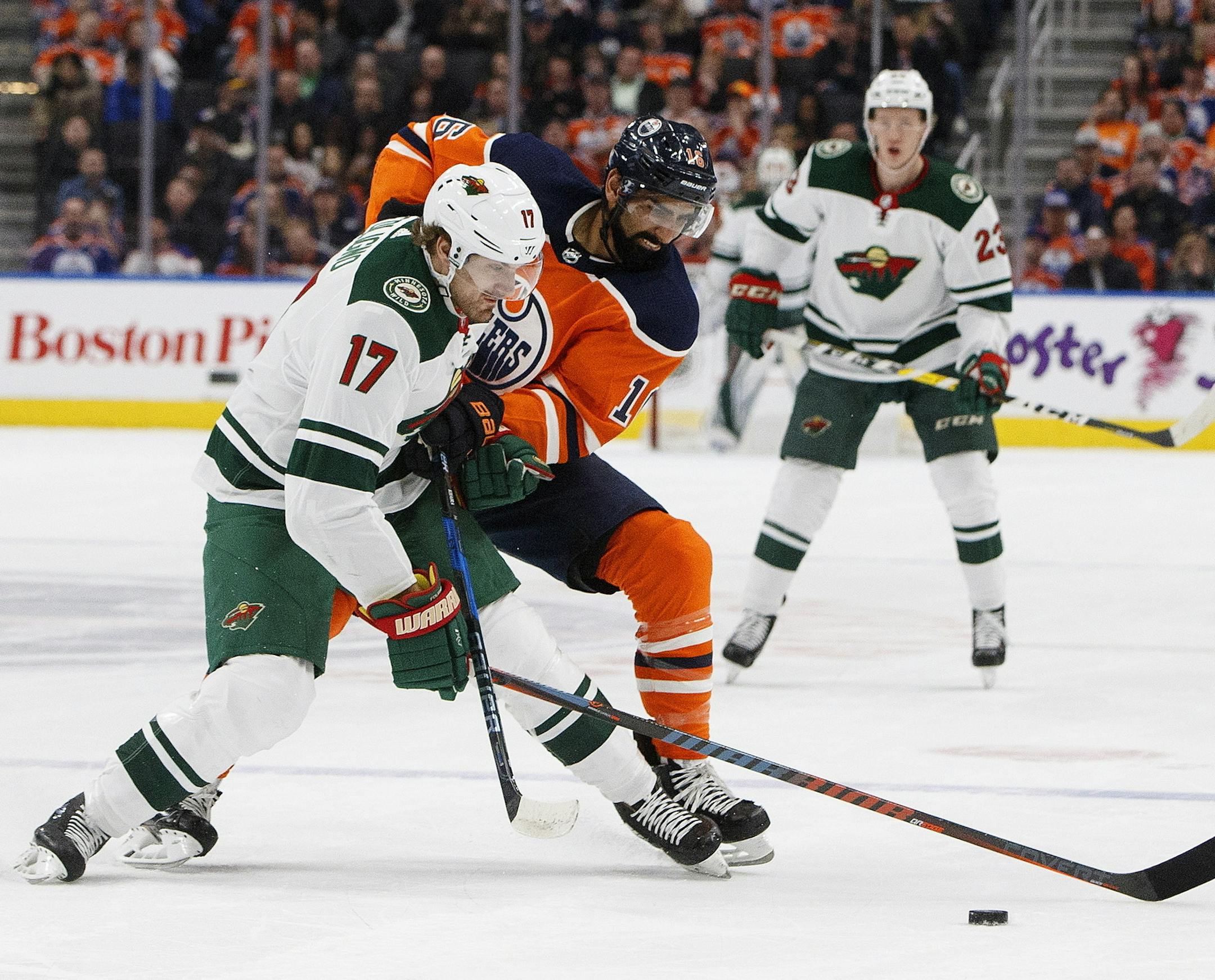 The Wild's Marcus Foligno and the Oilers' Jujhar Khaira battled for the puck Saturday night. The Oilers led 2-0 in the second period on two goals by Connor McDavid. Visit startribune.com for the result.