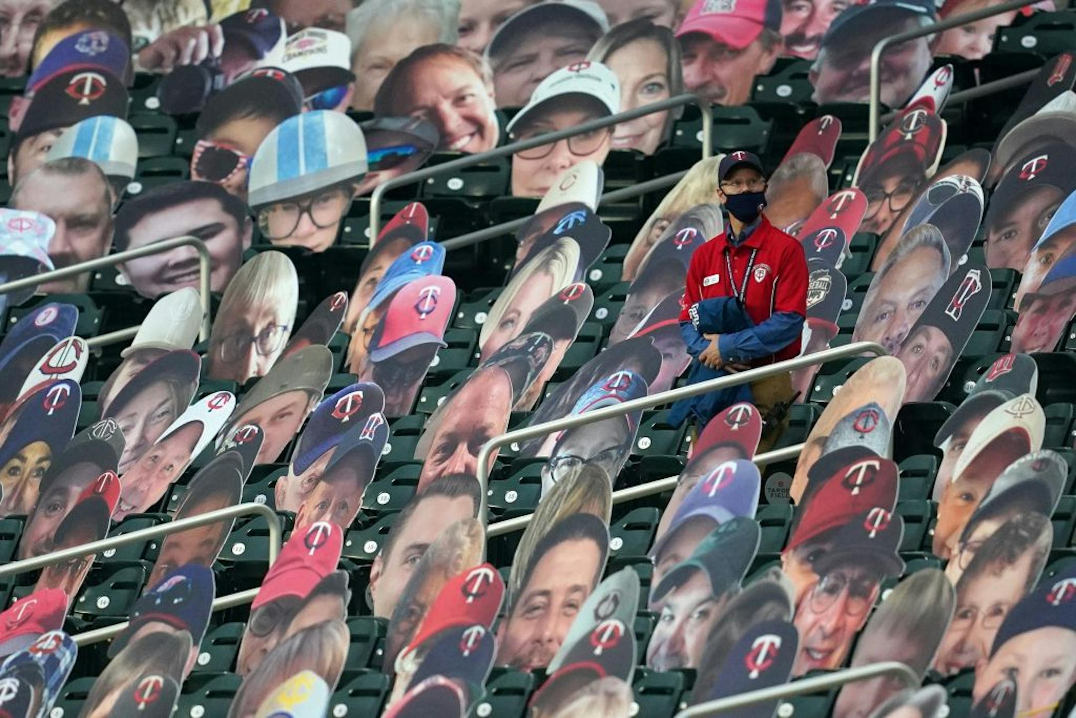 A real Minnesota Twins guest services worker stood among the cardboard cutouts ahead of Saturday's game.