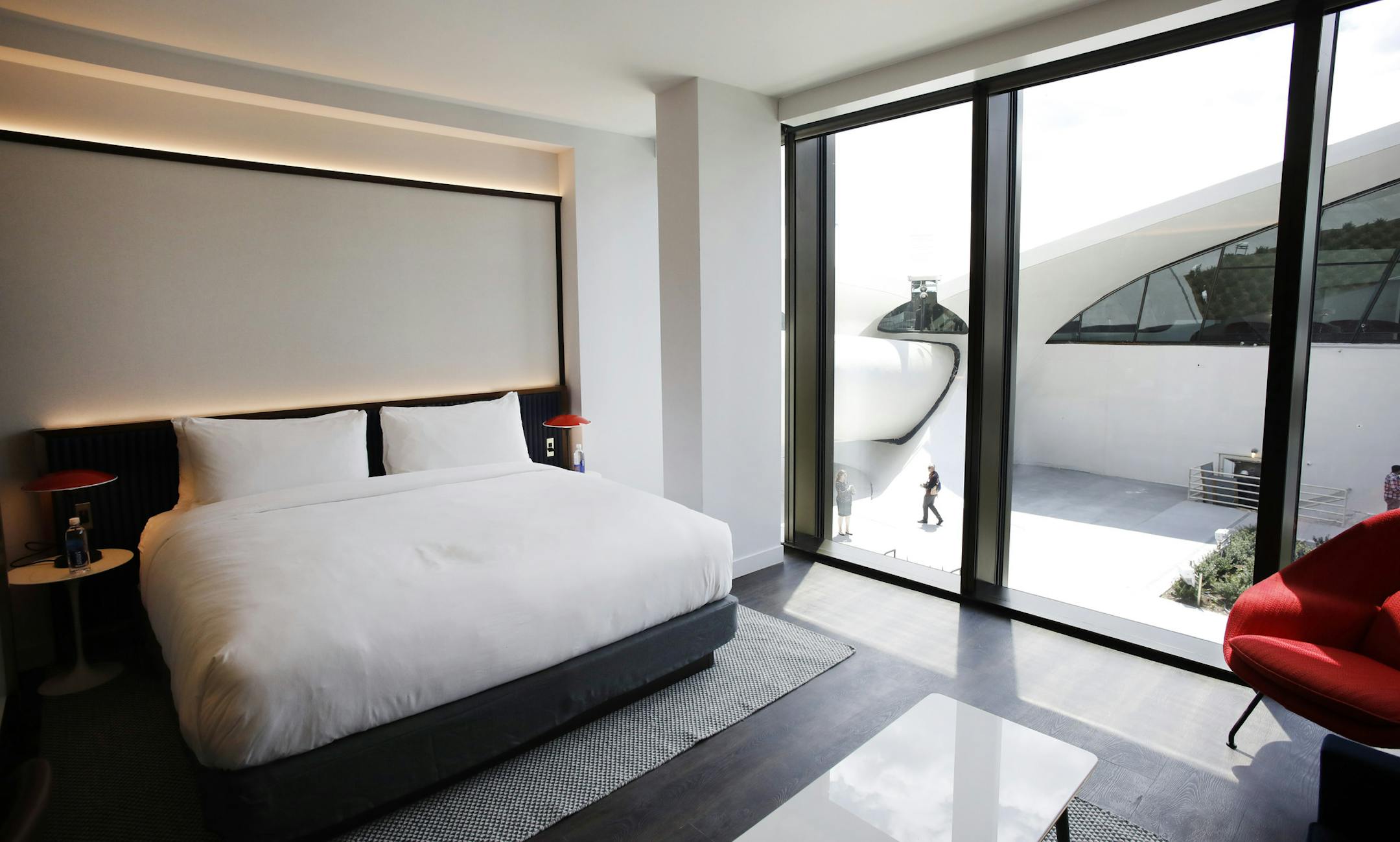 A room at the TWA Hotel at New York's John F. Kennedy International Airport has a view of the Eero Saarinen-designed terminal, Wednesday, May 15, 2019. (AP Photo/Mark Lennihan)