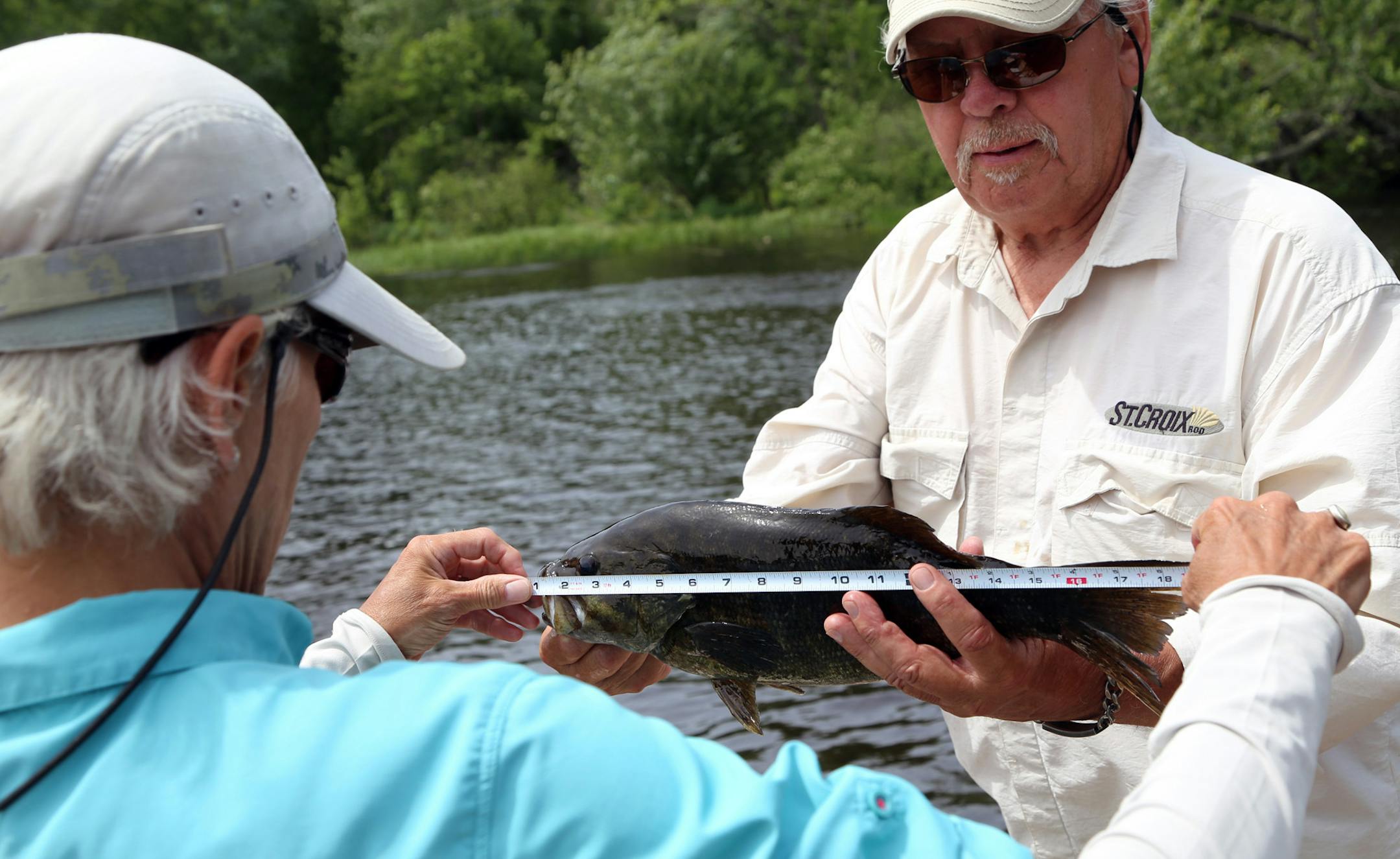 Put a tape to it: A smallmouth bass caught by Dennis Anderson measures 19 inches long.