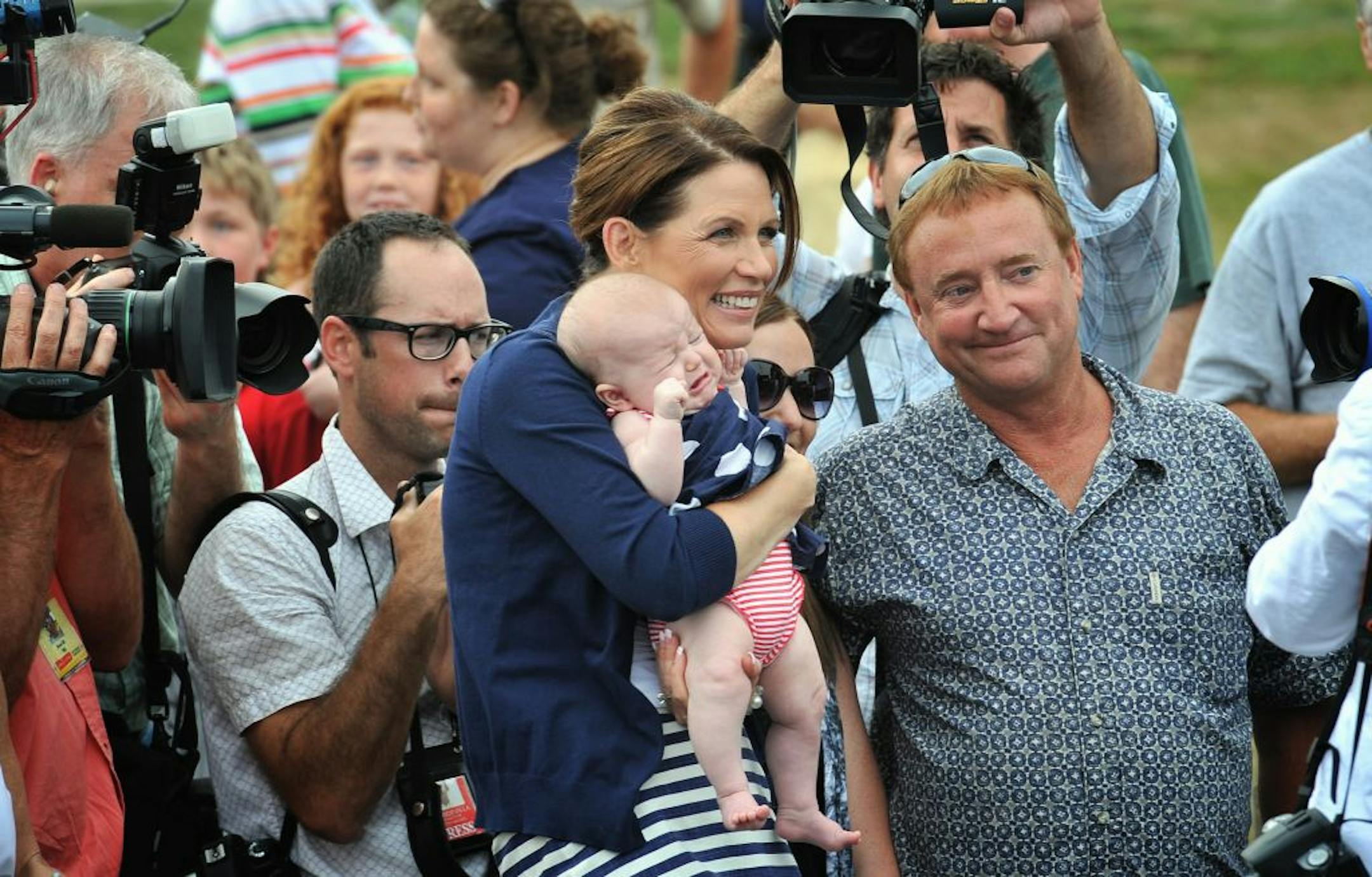 Michele Bachmann went for the time-honored baby-and-politician approach Tuesday as she sought support for the Iowa straw poll.