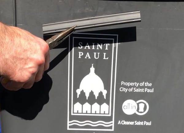 Peter Butler of St. Paul removed the chip that was embedded in his city-issued garbage bin.