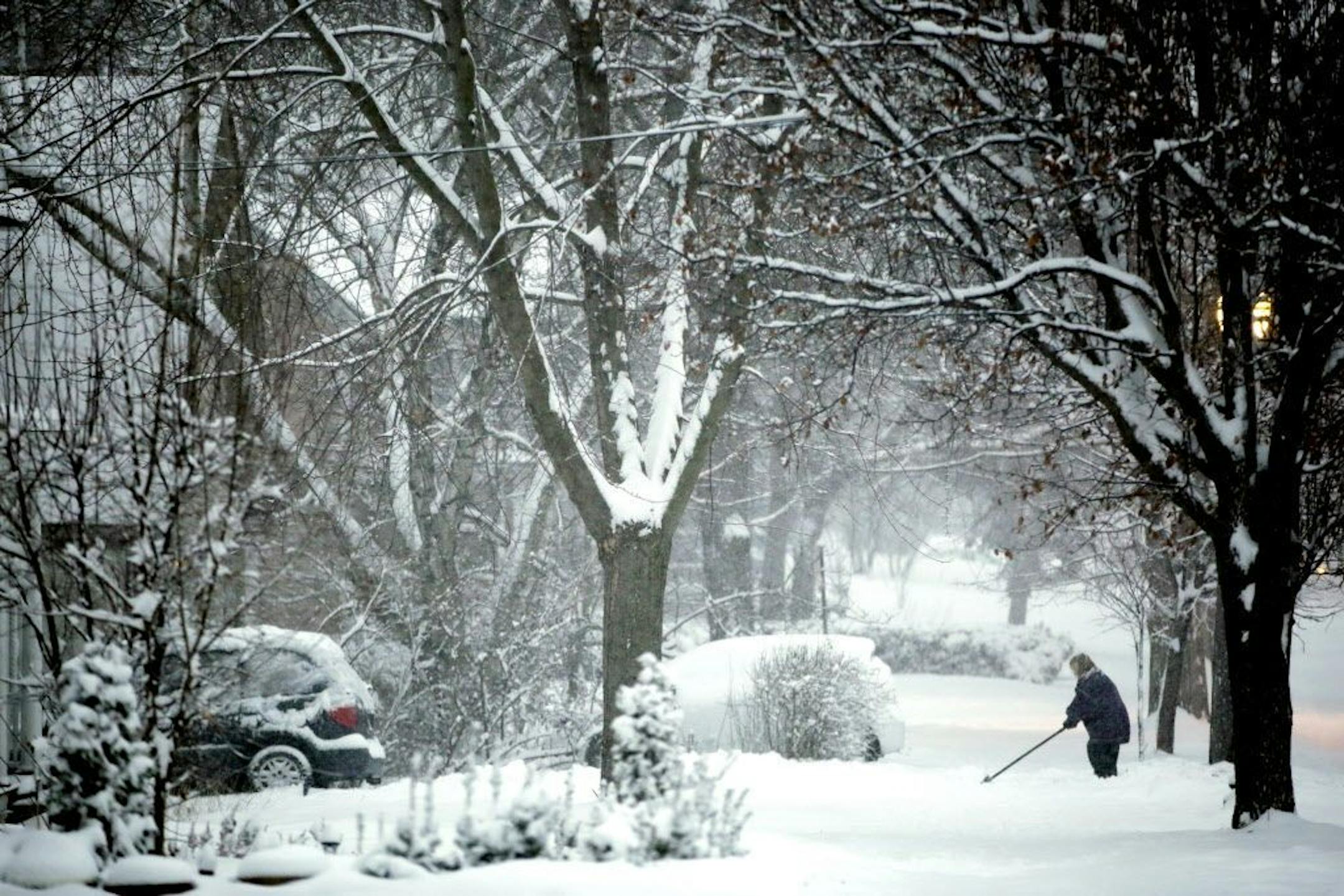 Jackie Johnson shovels out her driveway along East Chicago Street in Elgin, Ill., on Sunday, Feb. 1, 2015. An unusually slow-moving storm crawling into the Midwest is expected to be the most widespread of the season and could make driving to Super Bowl house parties a bad idea. The National Weather Service says between 8 and 14 inches of snow could fall in parts of New England beginning around midnight, with more in higher elevations. (AP Photo/Chicago Tribune, Stacey Wescott) MANDATORY CREDIT;