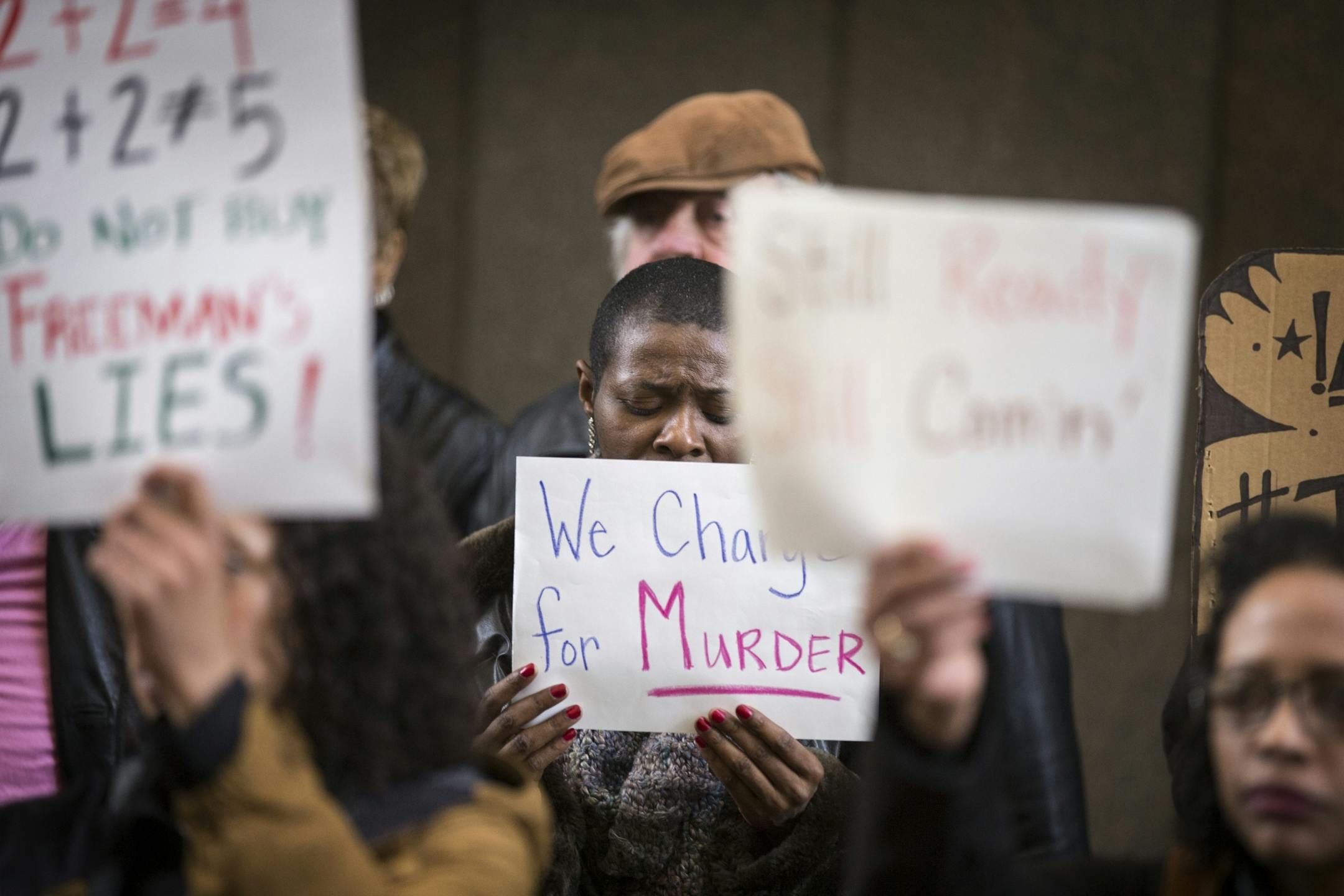 Daphne Brown takes a silent moment to herself during the "Freeman Friday" rally at Government Center.