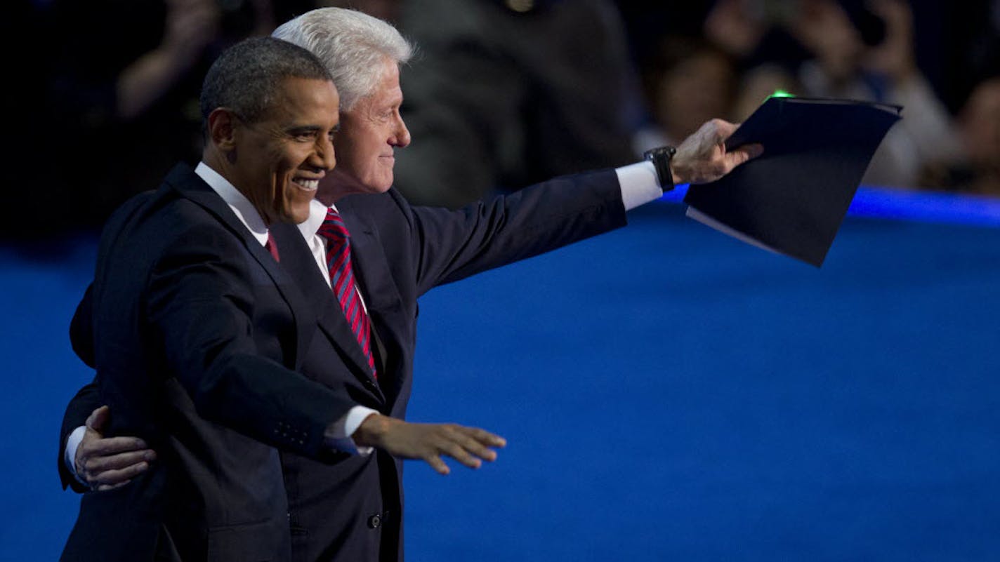 Former President Bill Clinton and President Barack Obama wave to delegates after Clinton's speech to the Democratic National Convention.