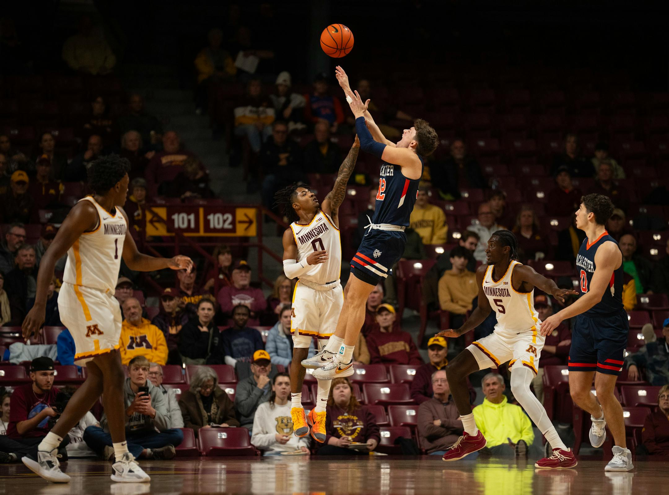 Macalester Scots guard Caleb Williams (32) shot over Minnesota Gophers guard Elijah Hawkins (0) in the first half. The University of Minnesota Gophers men's basketball team faced Macalester College in an exhibition game Thursday night, Nov. 2, 2023 at Williams Arena in Minneapolis.