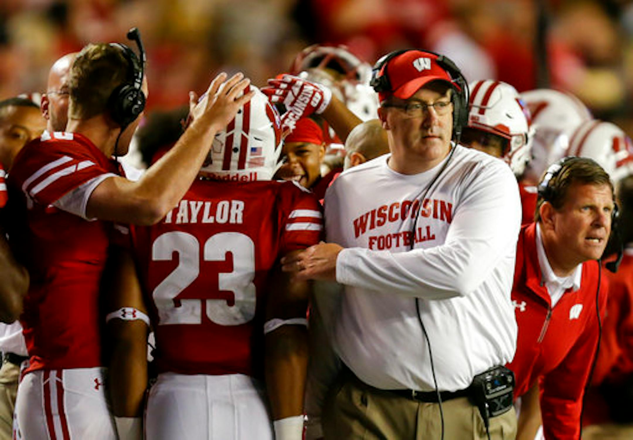 Wisconsin coach Paul Chryst congratulates Jonathan Taylor after Taylor scored a touchdown against Utah State during the second half of an NCAA college football game Friday, Sept. 1, 2017, in Madison, Wis. (AP Photo/Andy Manis)