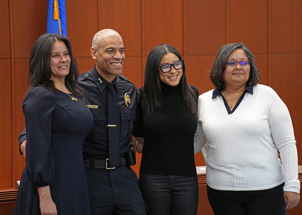 Ernest Morales III posed for photos at his swearing-in ceremony Wednesday with his wife, Yolanda, daughter Justina and sister Toni Figueroa.
