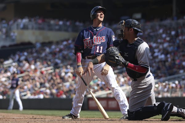 The Twins' Clete Thomas reacted after being called out on strikes in the eighth inning against the Yankees at Target Field on Thursday in a 9-5 defeat