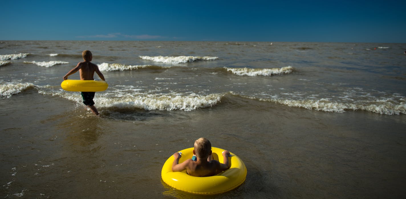 Brothers Trace, 11, left, and Isaiah Wiens, 6, of Steinbach, MB., played in the water at Grand Beach Provincial Park on Lake Winnipeg in Late August. ] (AARON LAVINSKY/STAR TRIBUNE) aaron.lavinsky@startribune.com RIVERS PROJECT: We look at three of Minnesota's rivers, including the Mississippi, Red and Chippewa, to see how land use effects water quality and pollution.