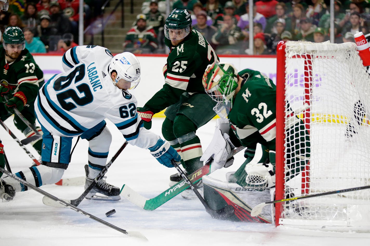 Minnesota Wild goaltender Filip Gustavsson (32) stops a shot by San Jose Sharks right wing Kevin Labanc (62) with Wild defenseman Jonas Brodin (25) and center Sam Steel (13) assisting in the second period of an NHL hockey game Sunday, Nov. 13, 2022, in St. Paul, Minn. (AP Photo/Andy Clayton-King)