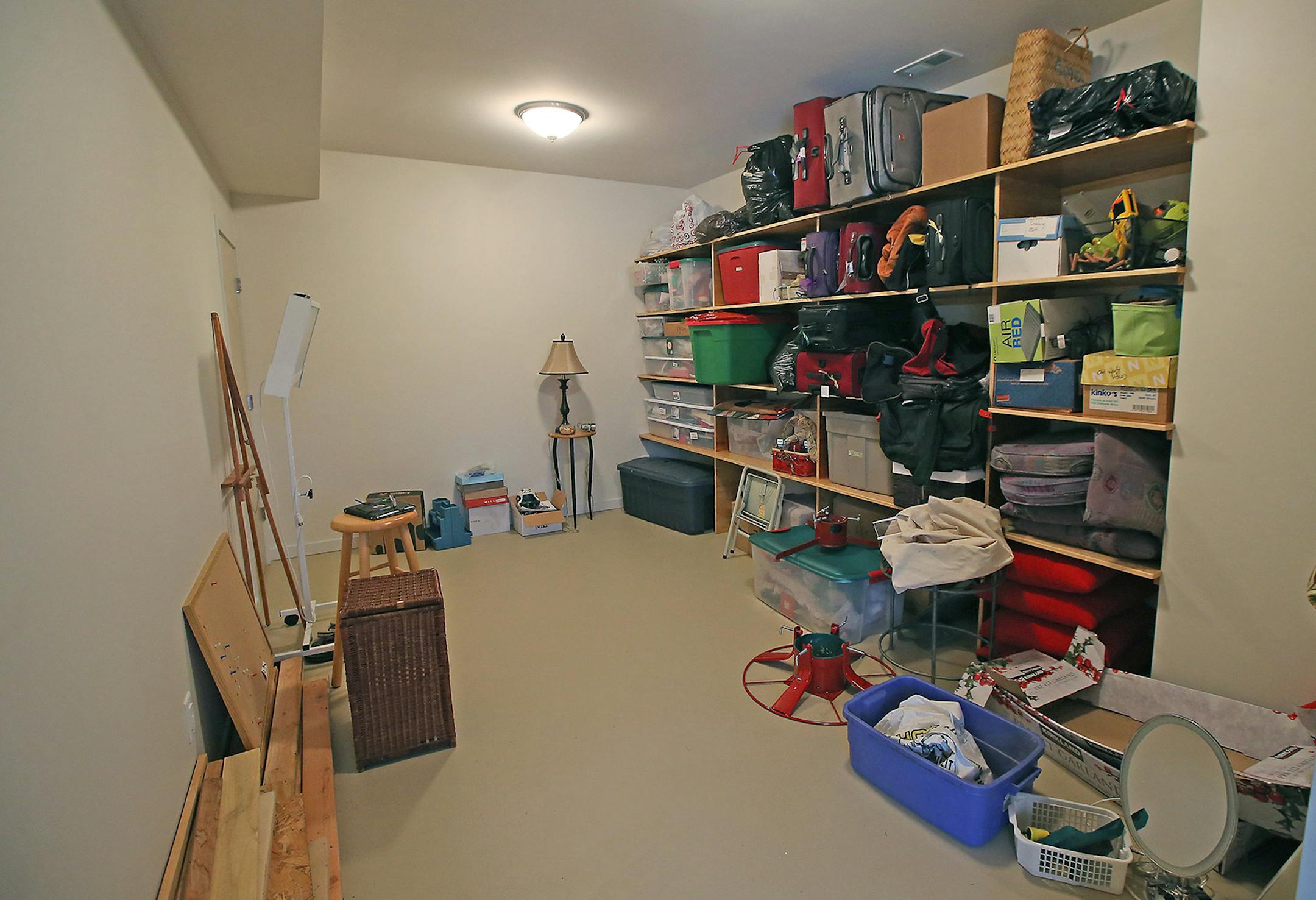 An enclosed storage room with shelving makes better use of the space under the porch.